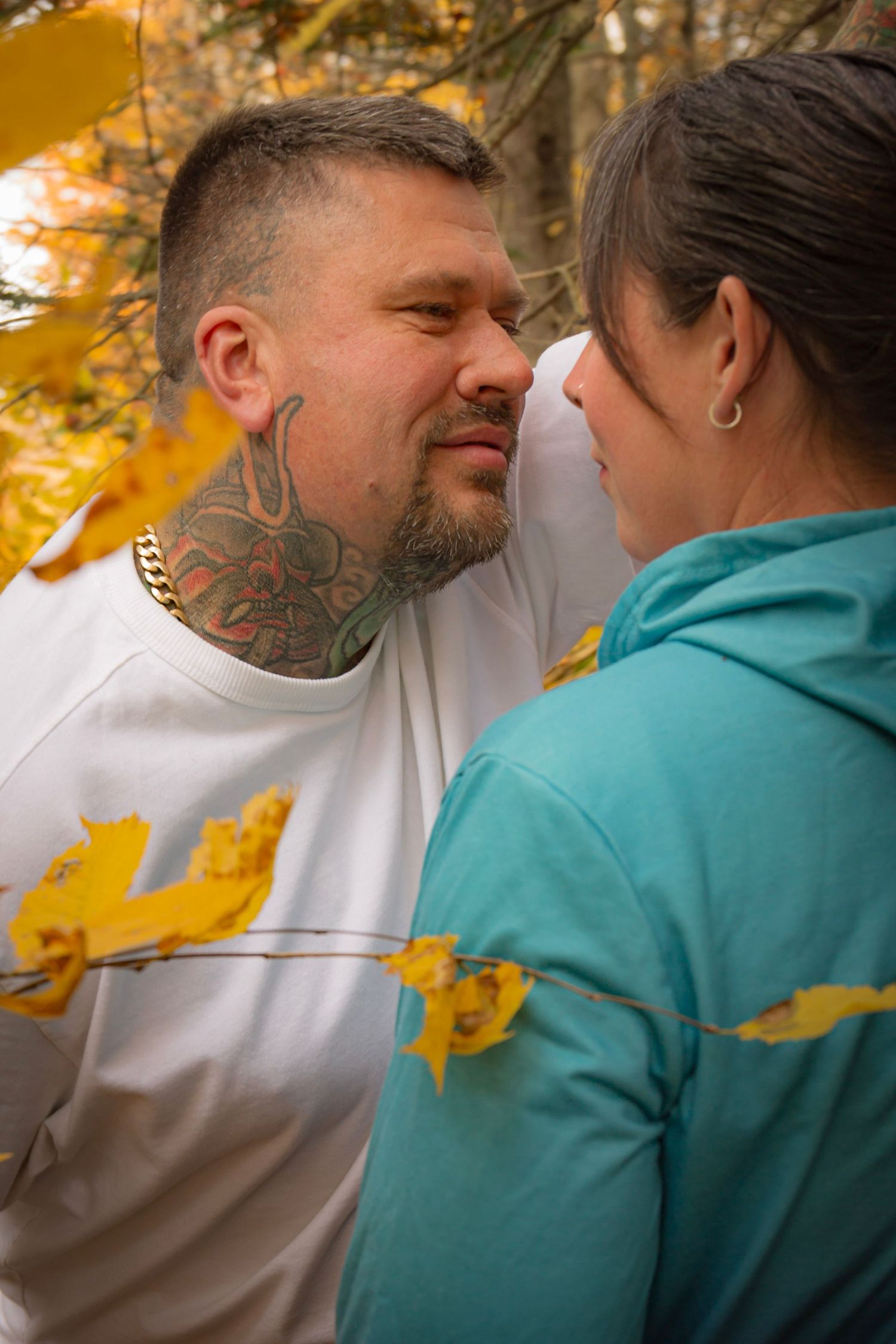 couple, looking at eachother, in fall, forest setting