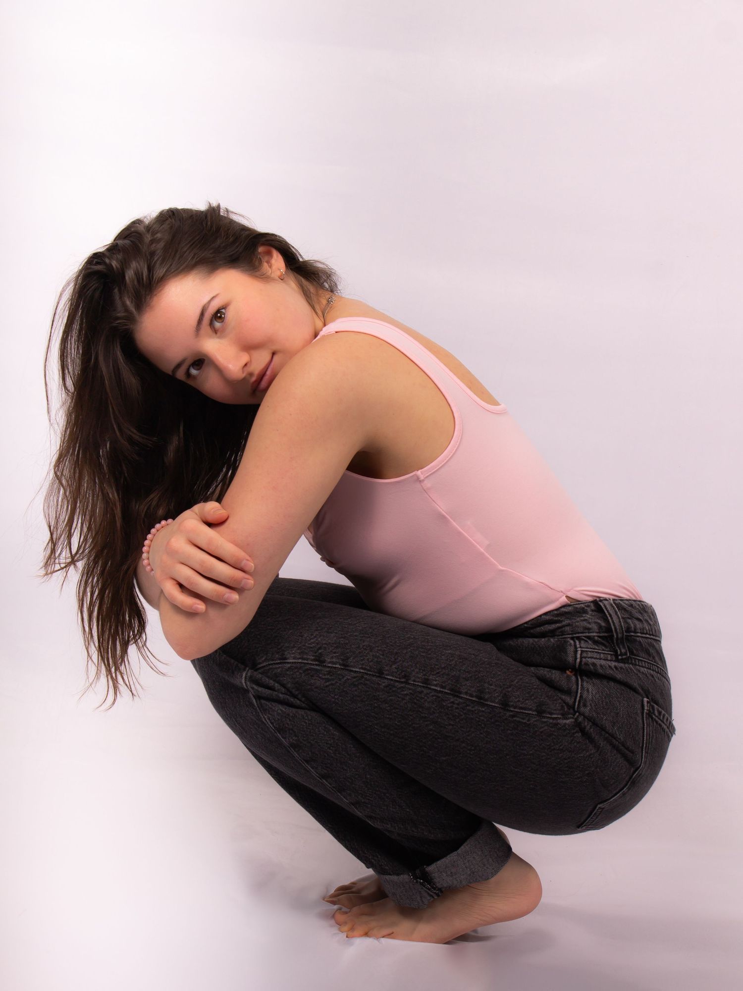 woman in fetal position in studio setting