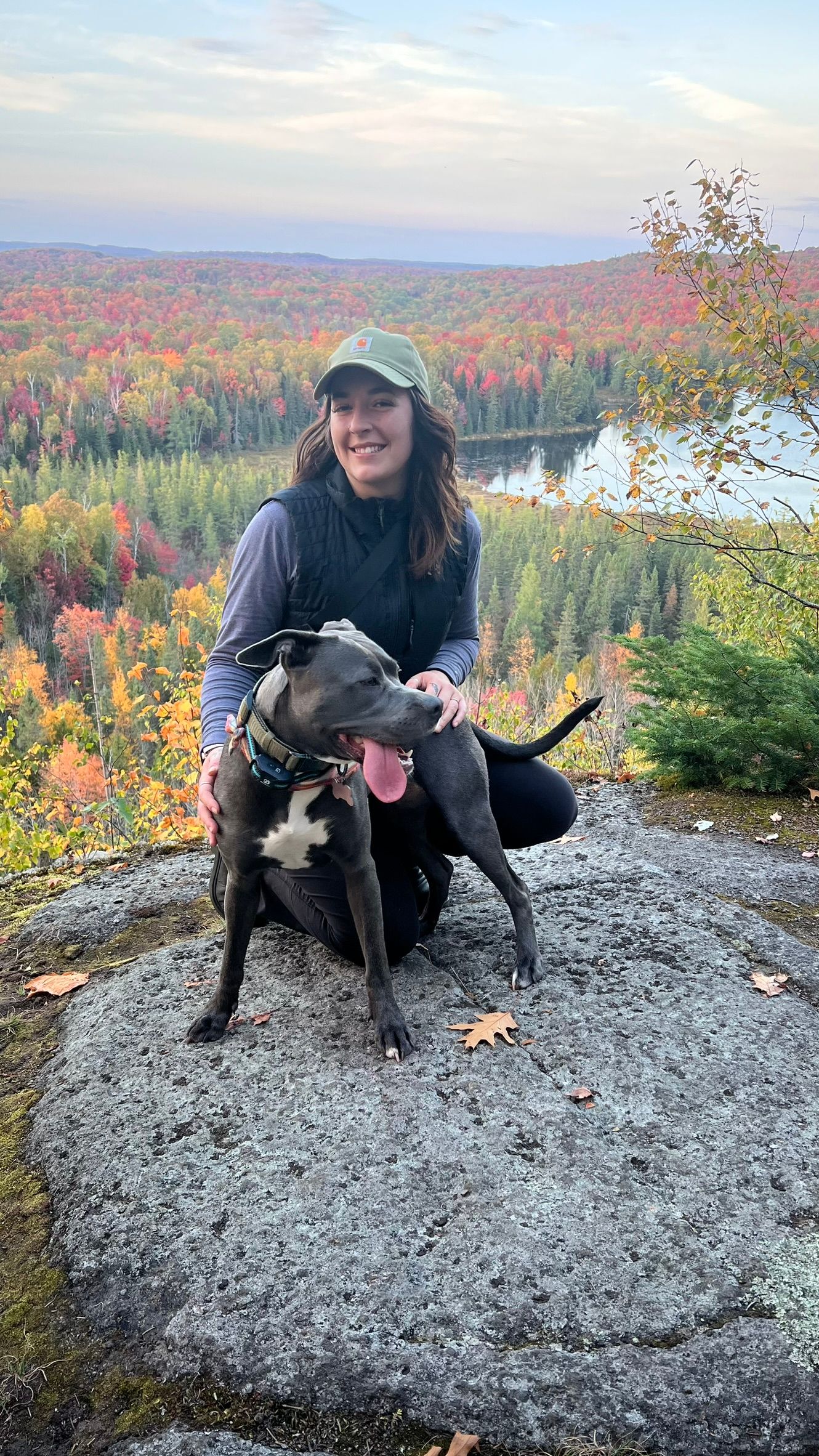 woman with dog in fall landscape setting