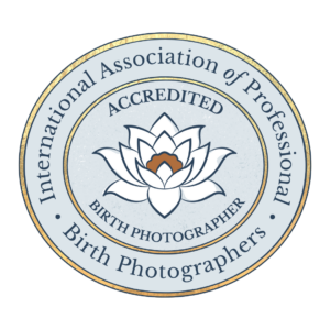 Circular logo for International Association of Professional Birth Photographers with white lotus flower design.