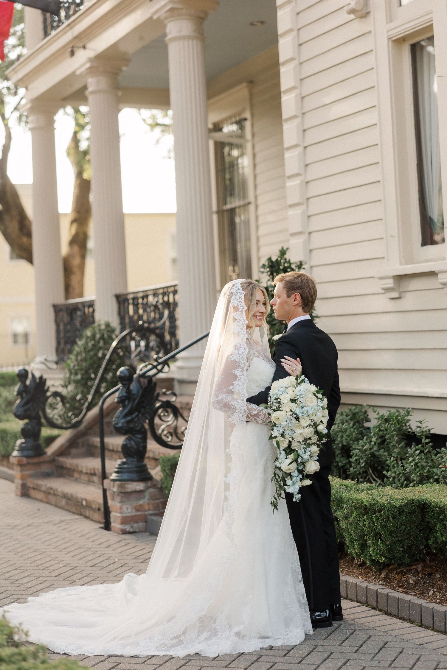 A series of romantic wedding photos showing a couple in formal attire on an elegant white columned porch.