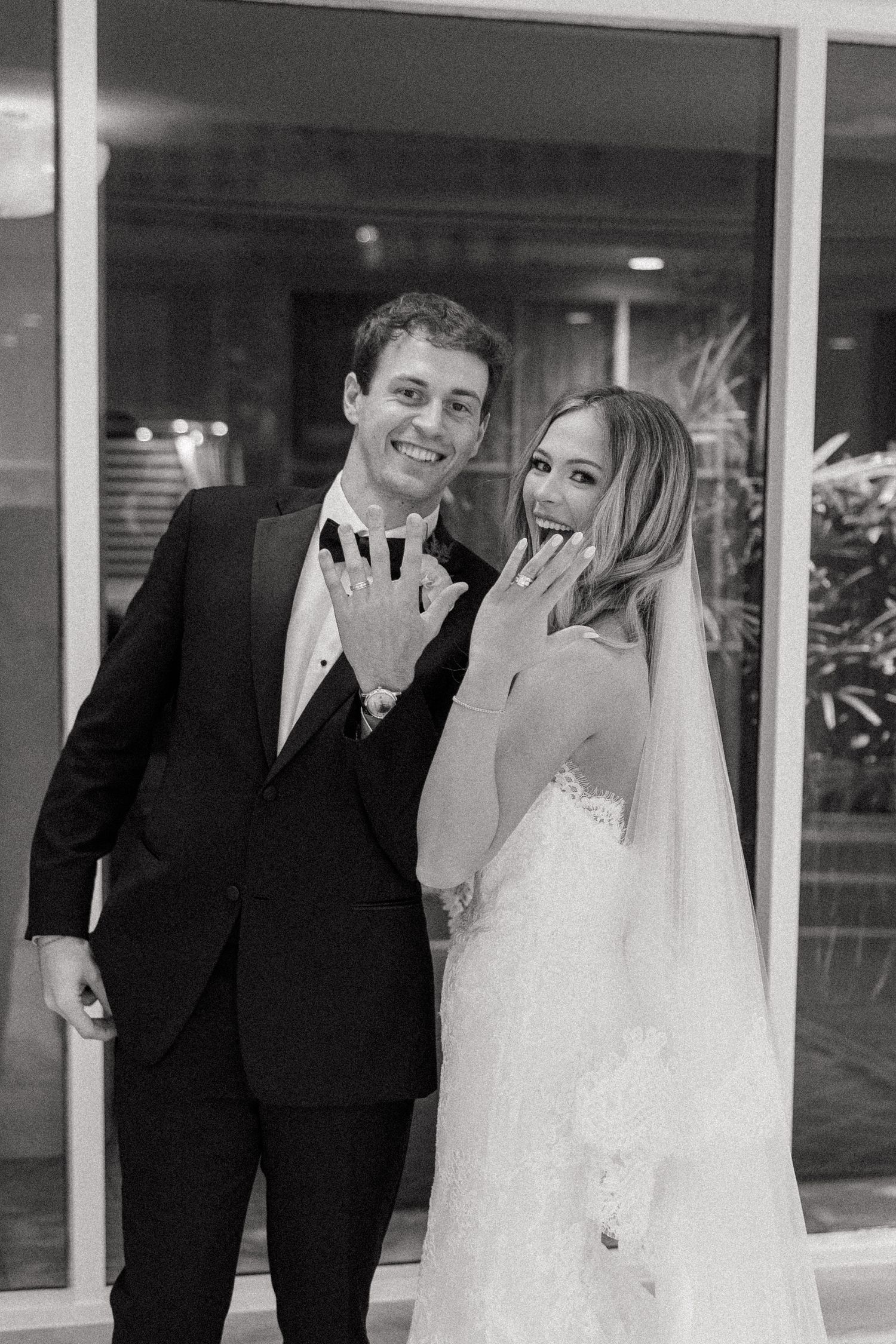 Candid black and white wedding photos capturing joyful moments between newlyweds.