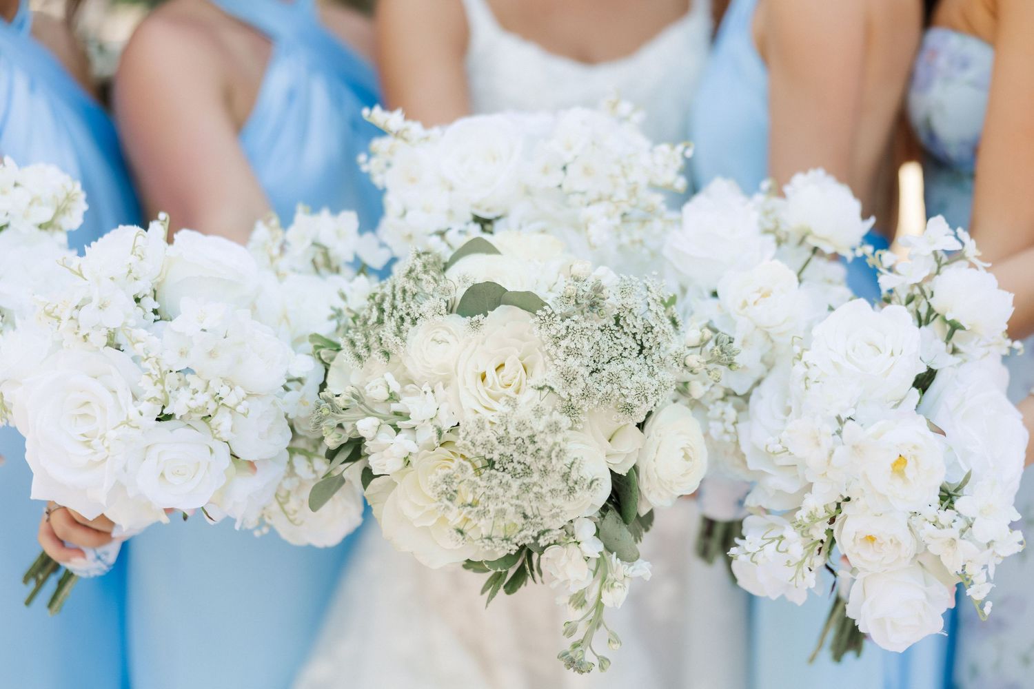 Beautiful white and blue floral bouquets featuring hydrangeas and roses in soft natural light.