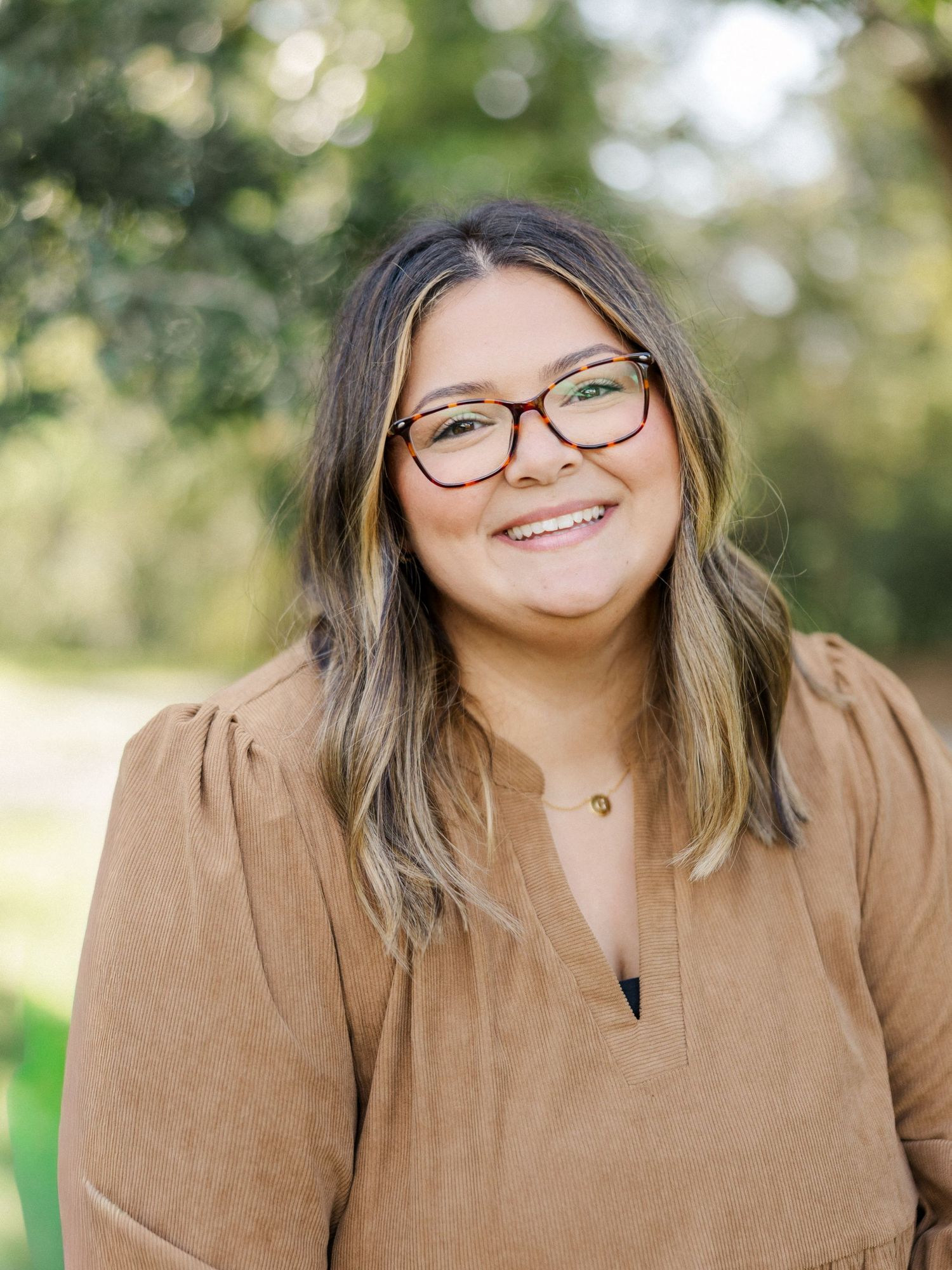 A series of outdoor portrait photos showing someone in a brown sweater with glasses against a natural blurred background.