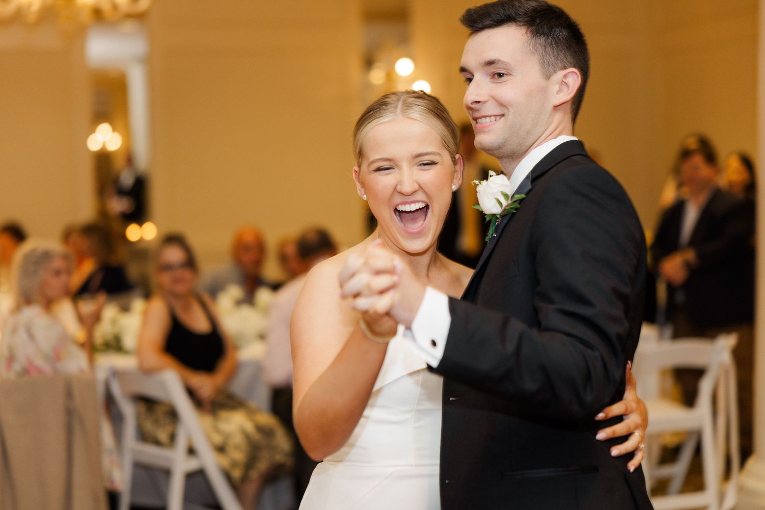 Joyful wedding reception celebration with dancing and laughter.
