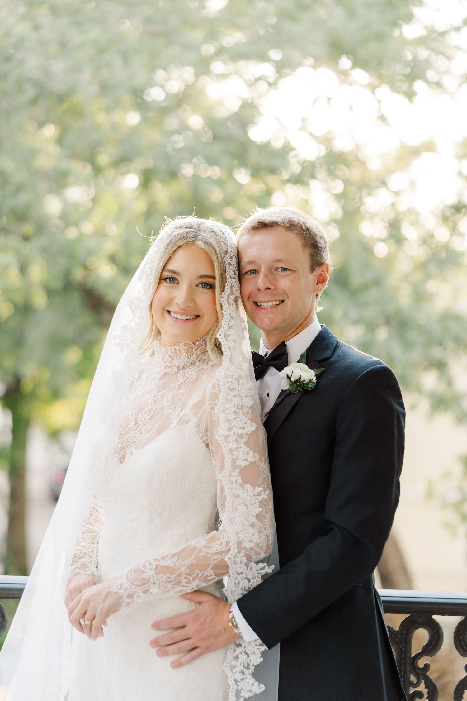 Romantic wedding portraits captured on an elegant veranda with soft natural lighting.