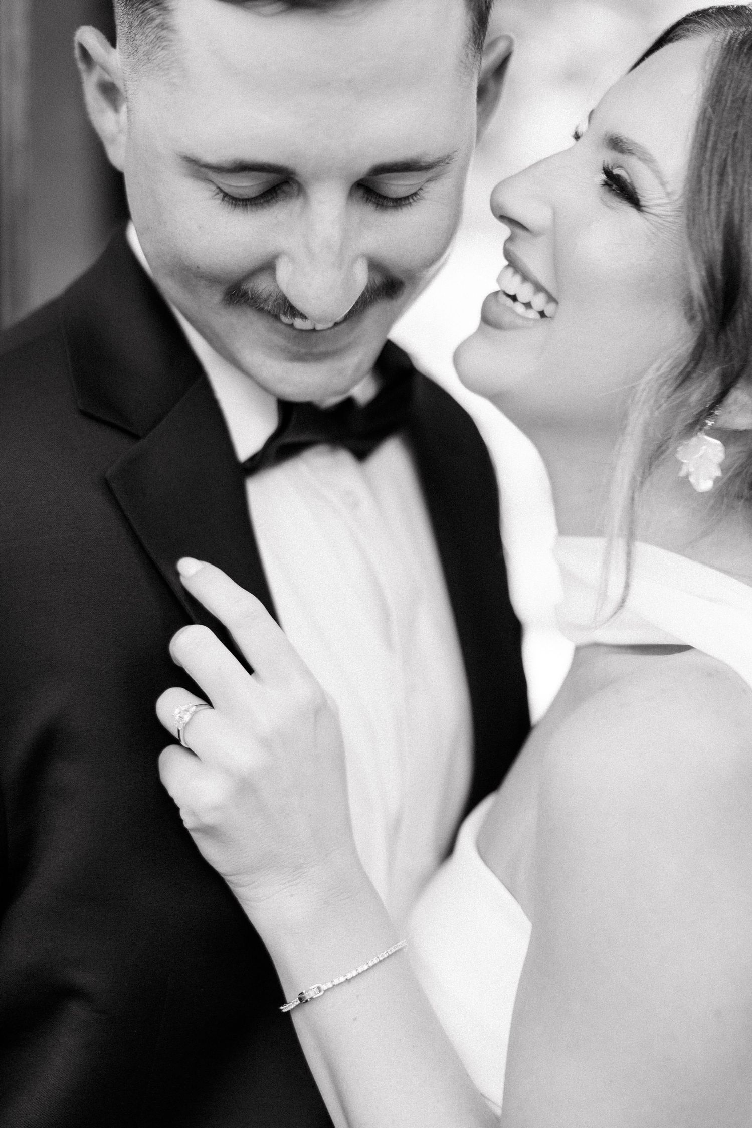 Black and white romantic wedding photography captures intimate close-up moments between newlyweds.