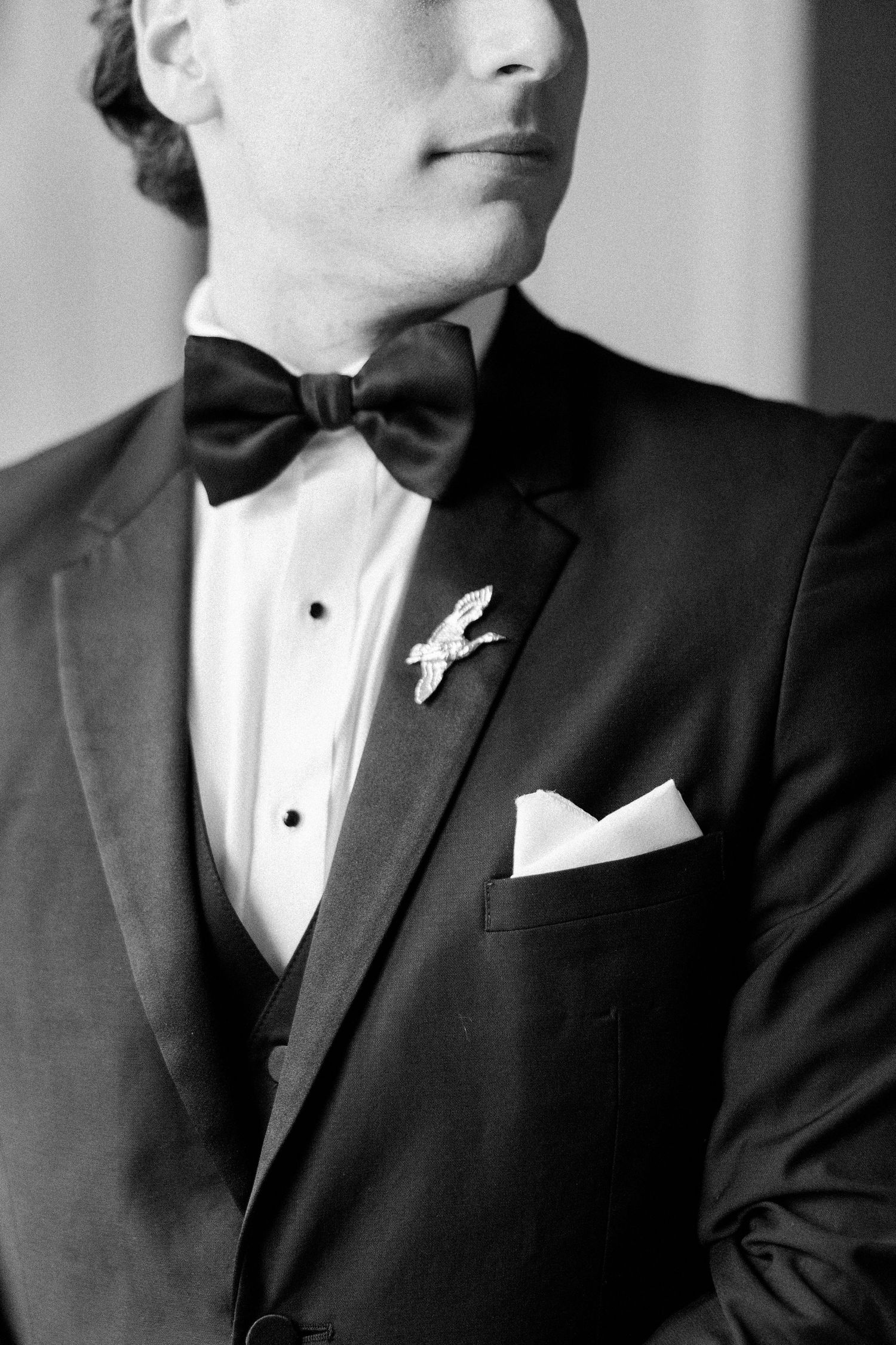 Black and white close-up detail shots of formal tuxedo attire.
