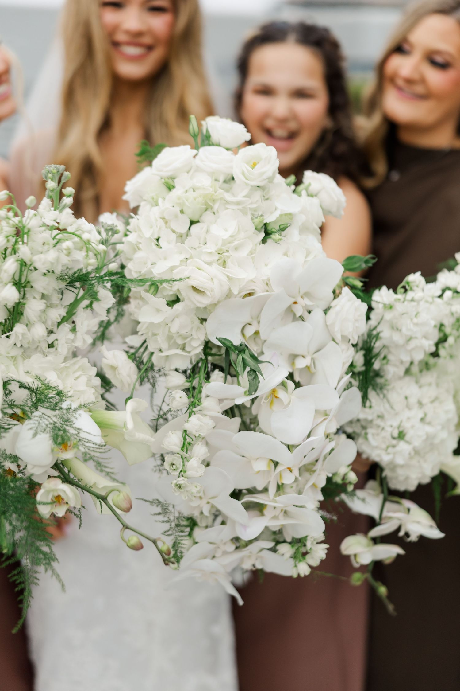 Elegant white orchid and floral bouquets arranged for wedding ceremony.
