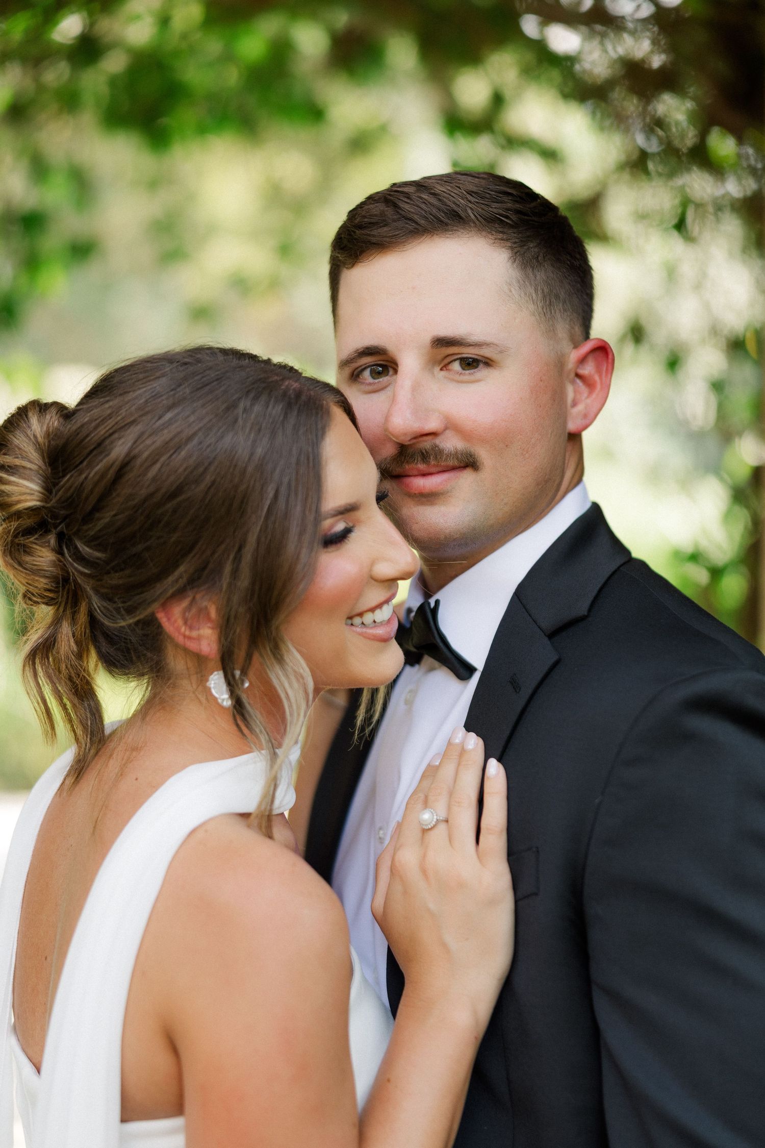 A romantic wedding moment captured in a series of intimate poses between a bride and groom outdoors.
