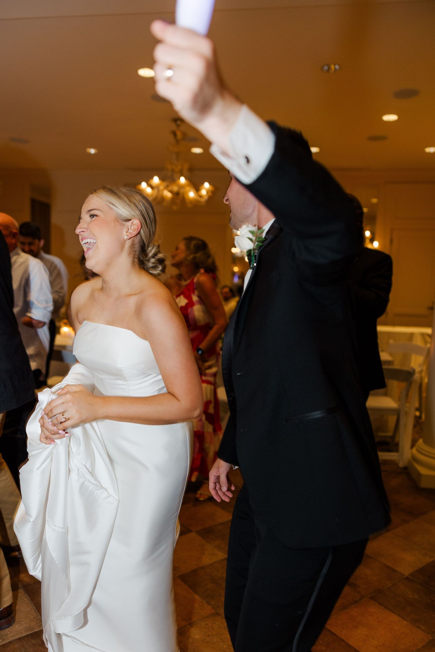 Wedding couple dancing and celebrating at their reception in formal attire.