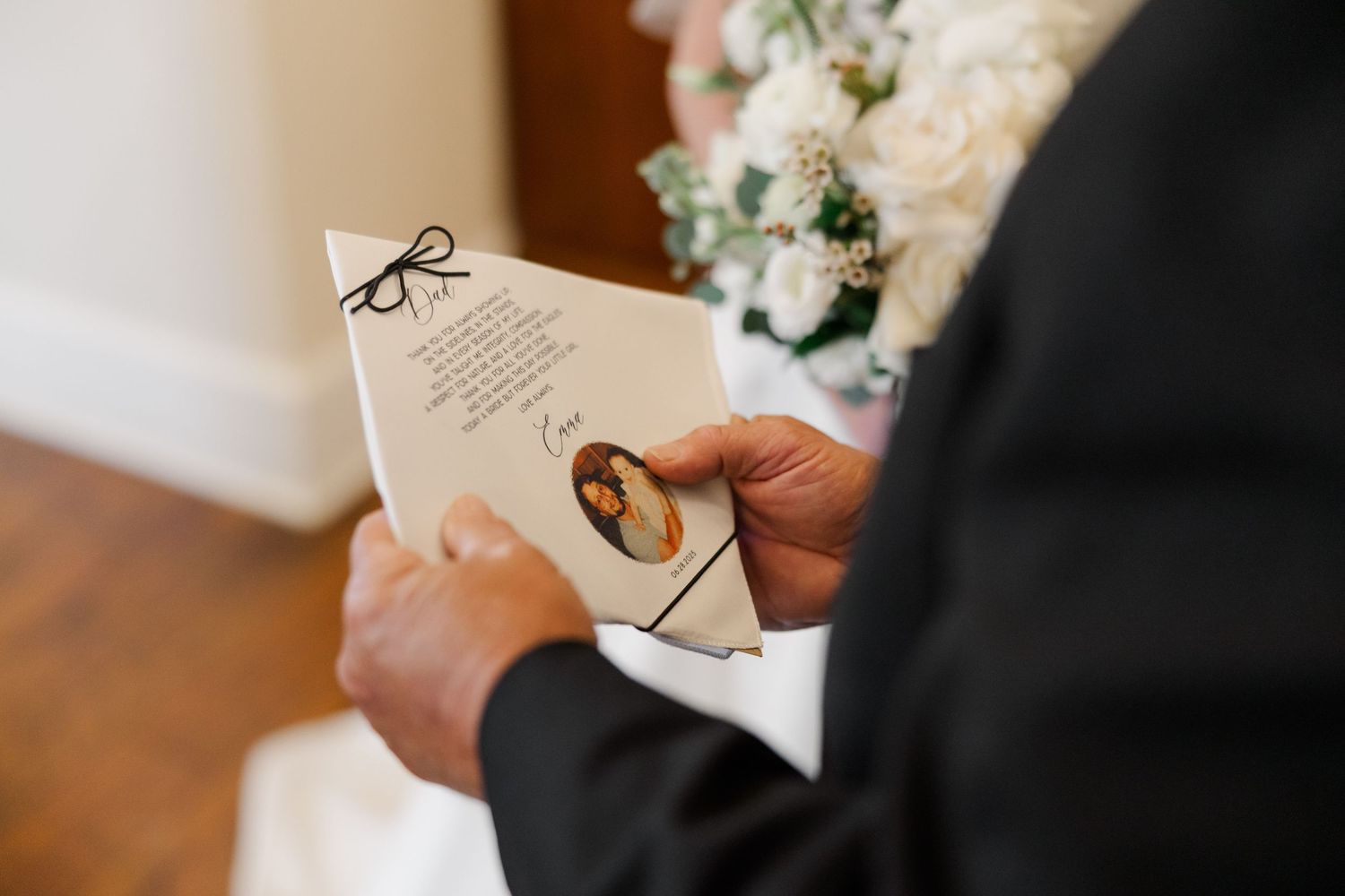 Close-up shots of hands holding wedding invitation cards with elegant calligraphy.