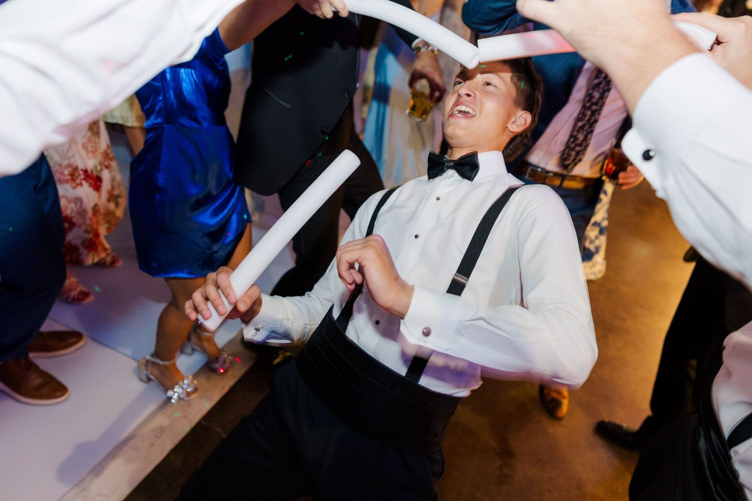 Energetic wedding reception dancing captured in a sequence of candid moments.