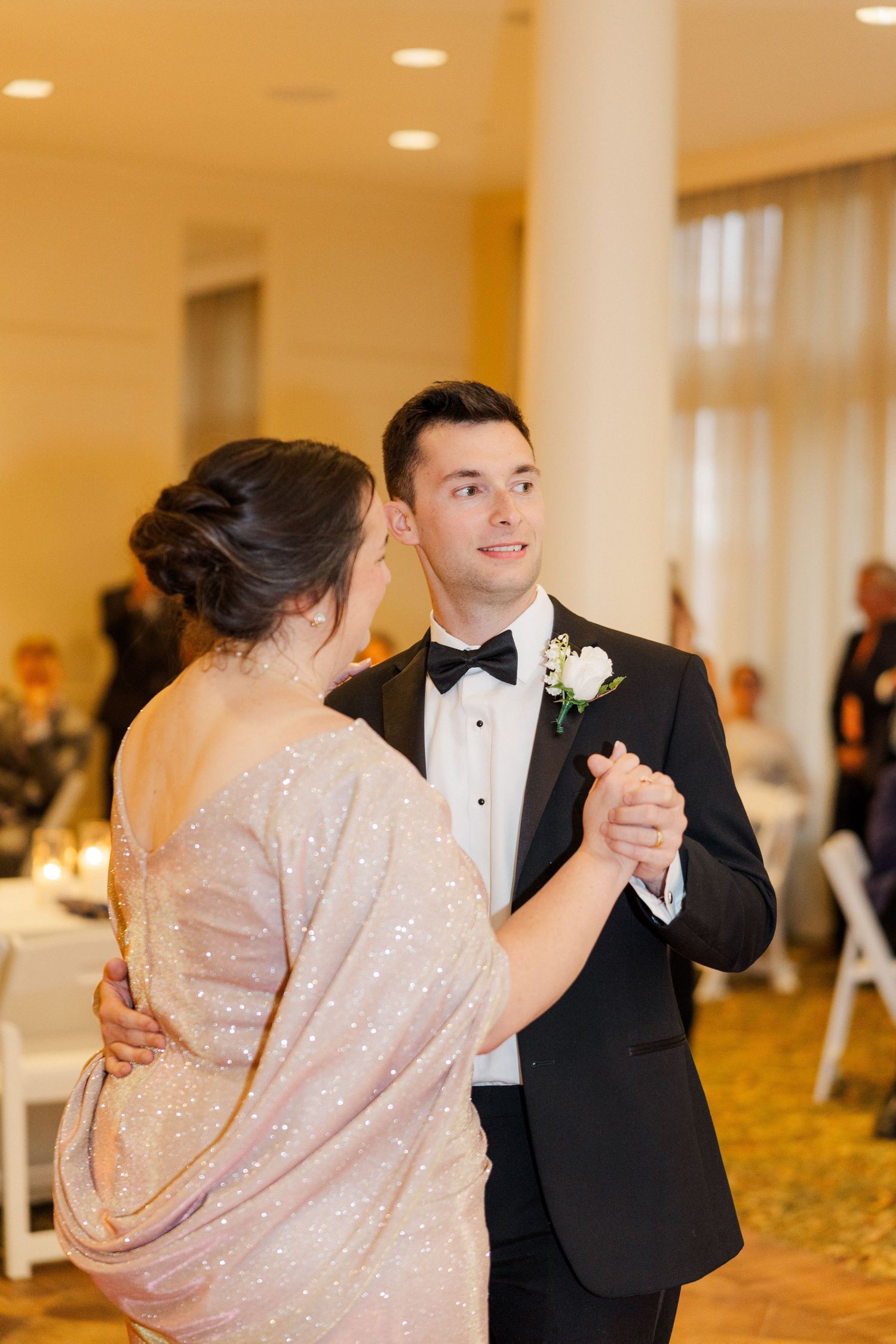 Couple dances gracefully in formal attire during their wedding reception.