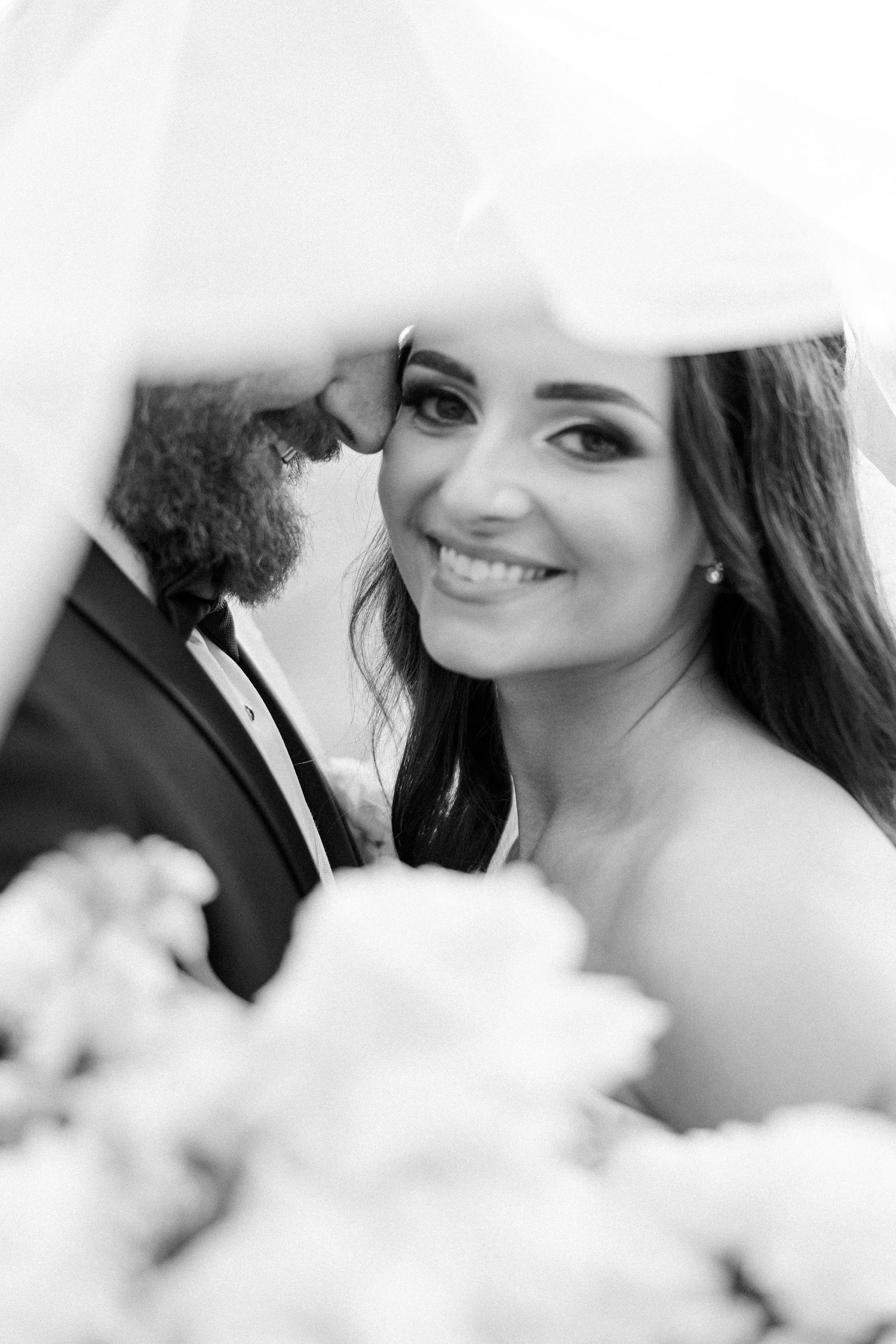 Black and white close-up wedding portraits showing tender romantic moments between newlyweds.