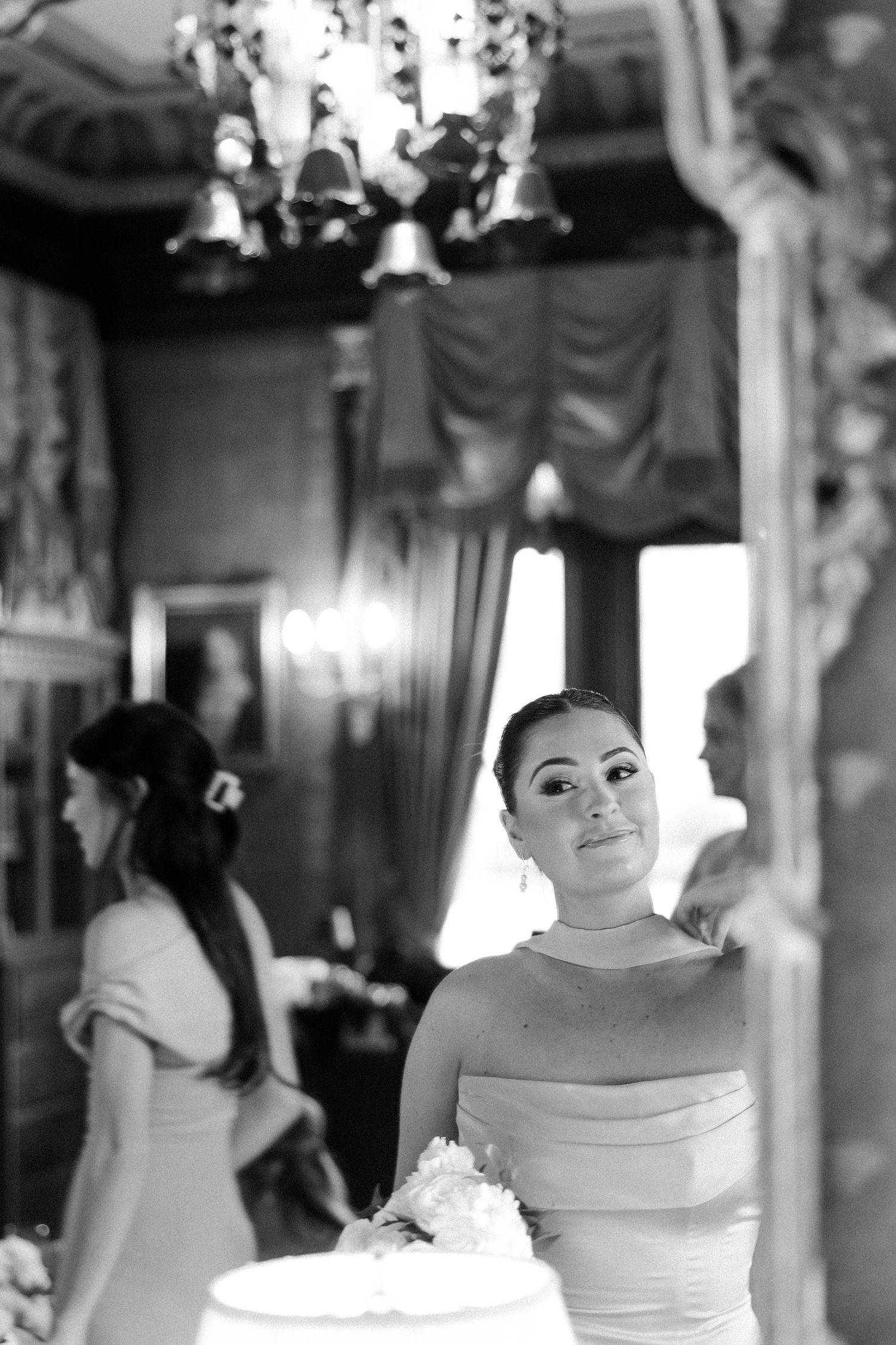Black and white photo series showing a bride getting ready in an elegant room with vintage decor.