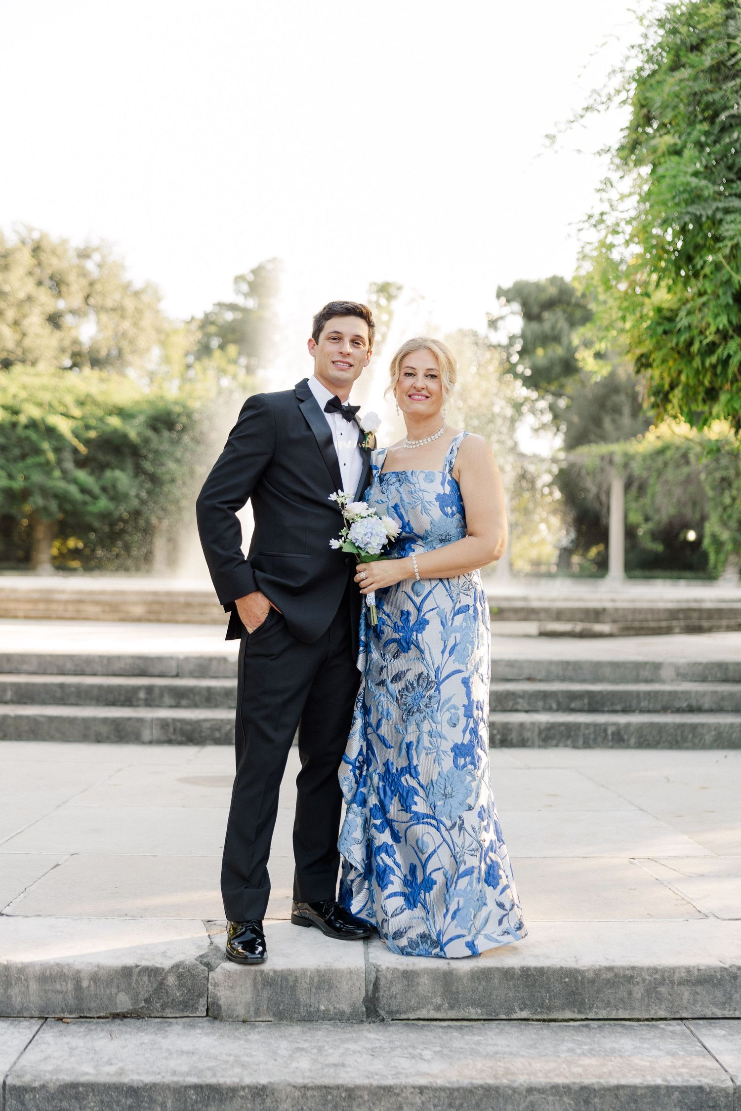 Wedding photos on concrete steps featuring formal attire and blue floral dress.