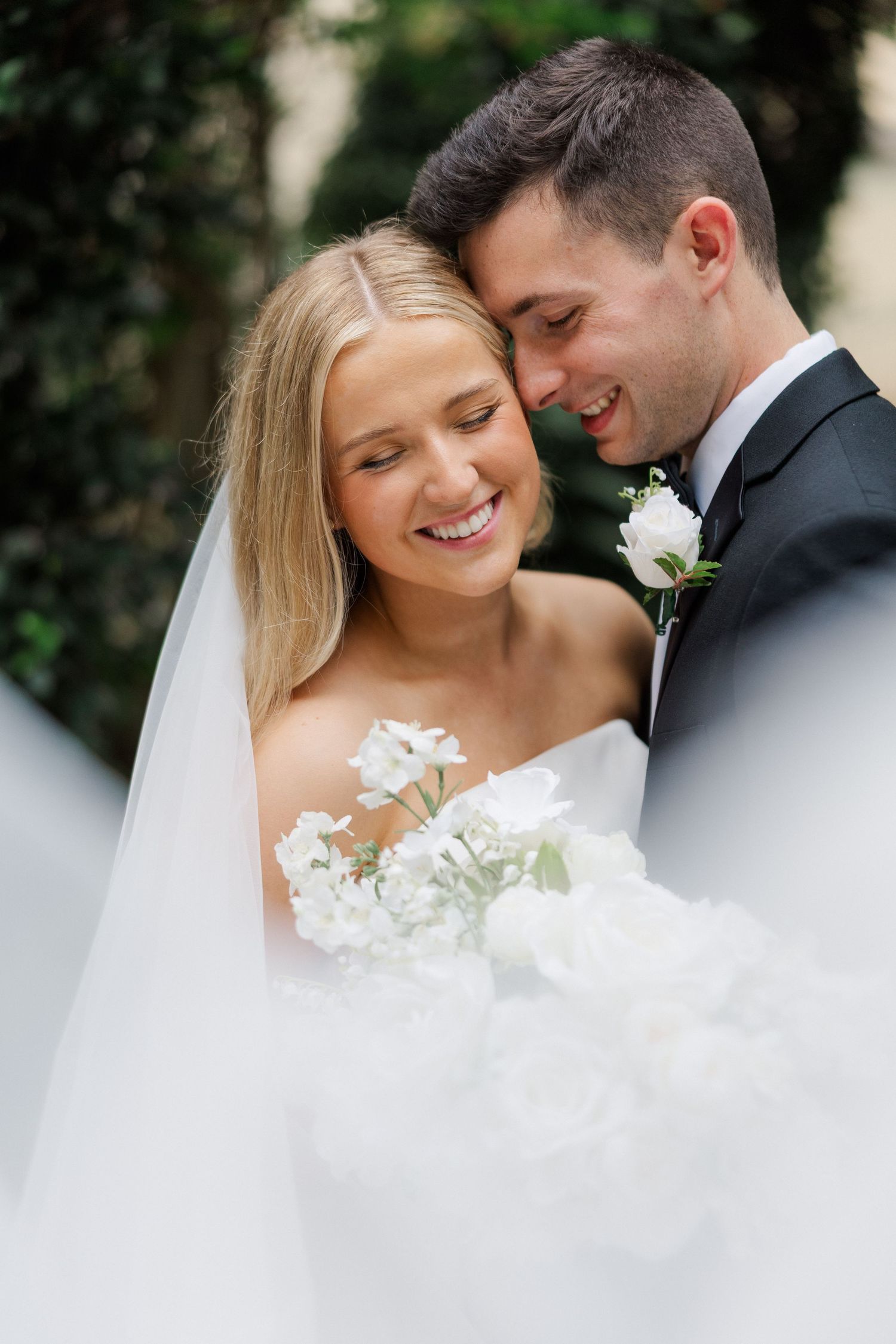 Intimate wedding portrait moments captured in a romantic outdoor garden setting.