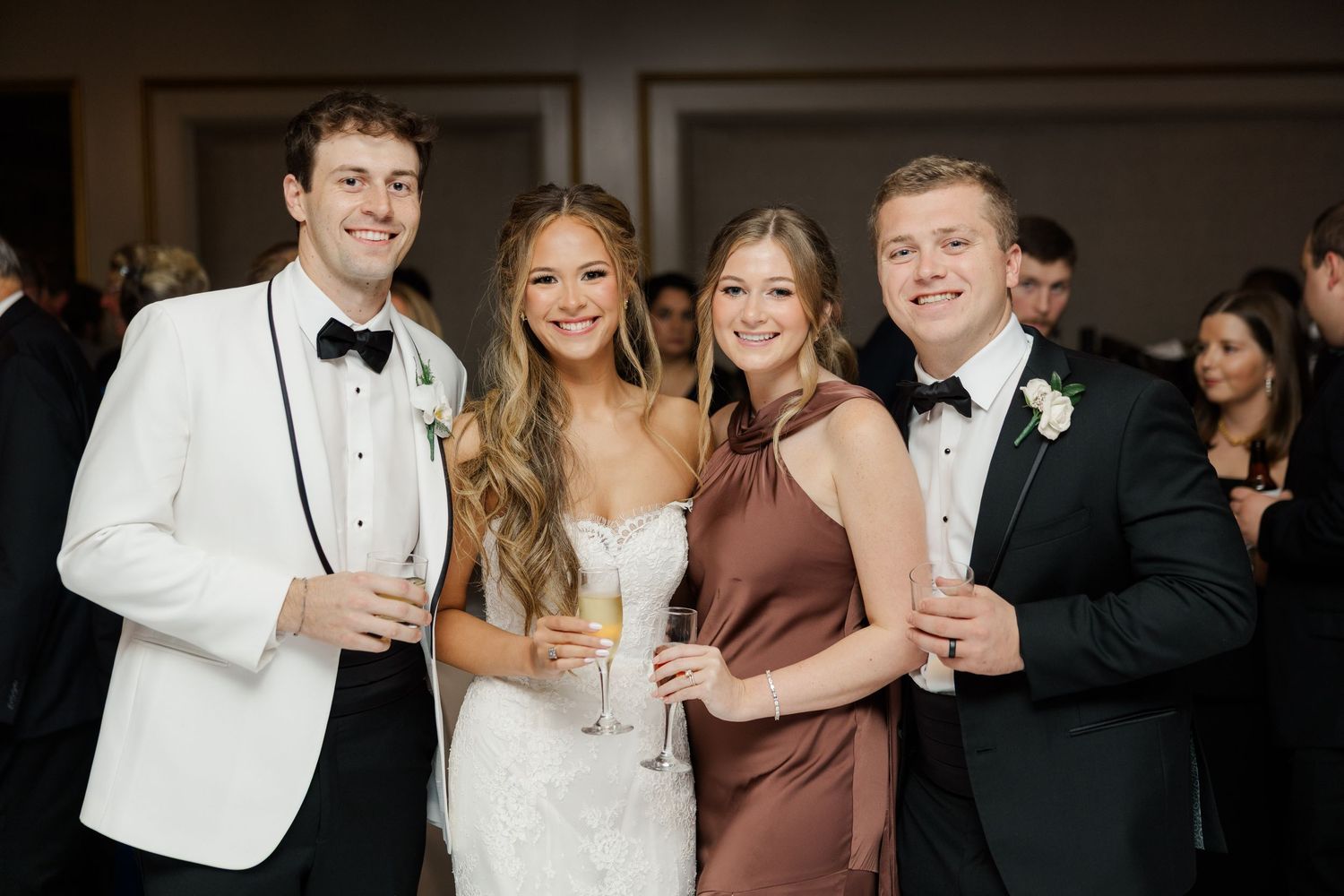Wedding reception celebration with guests in formal attire.