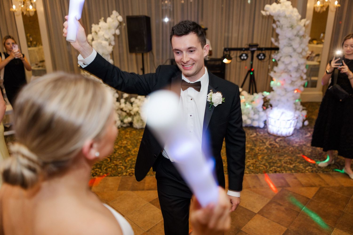 Wedding reception dance floor with colorful lighting and festive atmosphere.