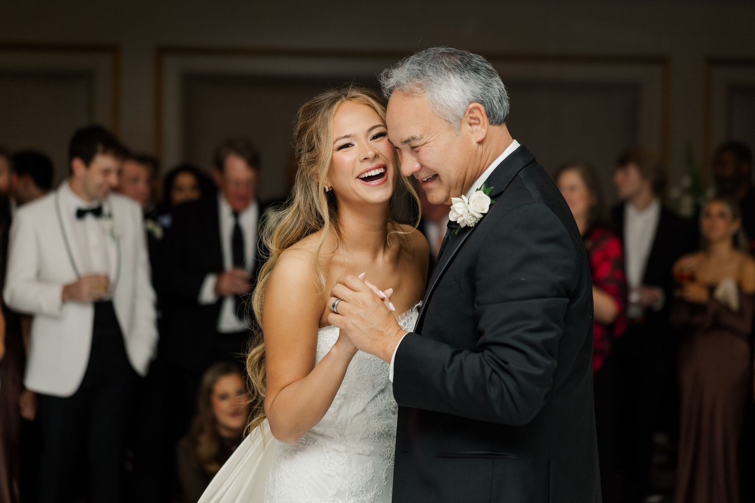 Romantic first dance moment at an elegant indoor wedding reception.