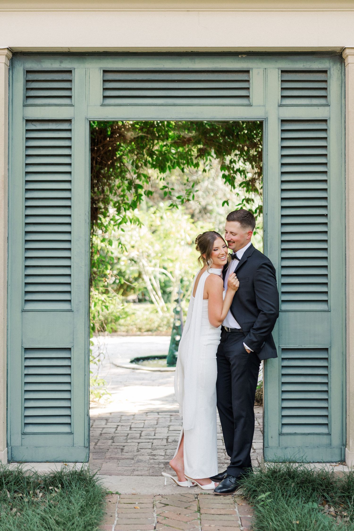 Romantic wedding couple poses against rustic green shutters in three intimate portrait shots.