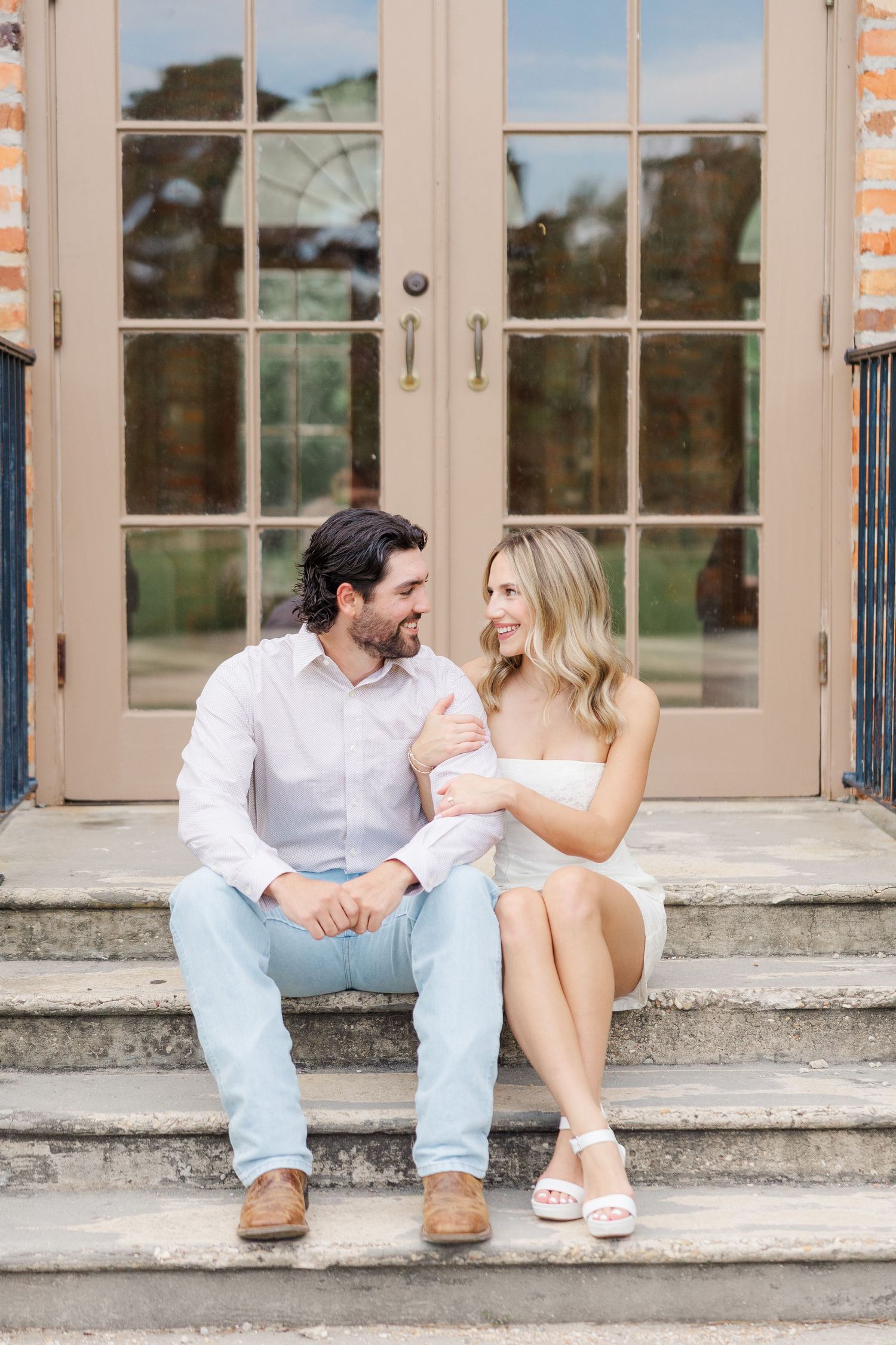 A couple sits together on concrete steps outside French doors, shown in a series of three connected photos.