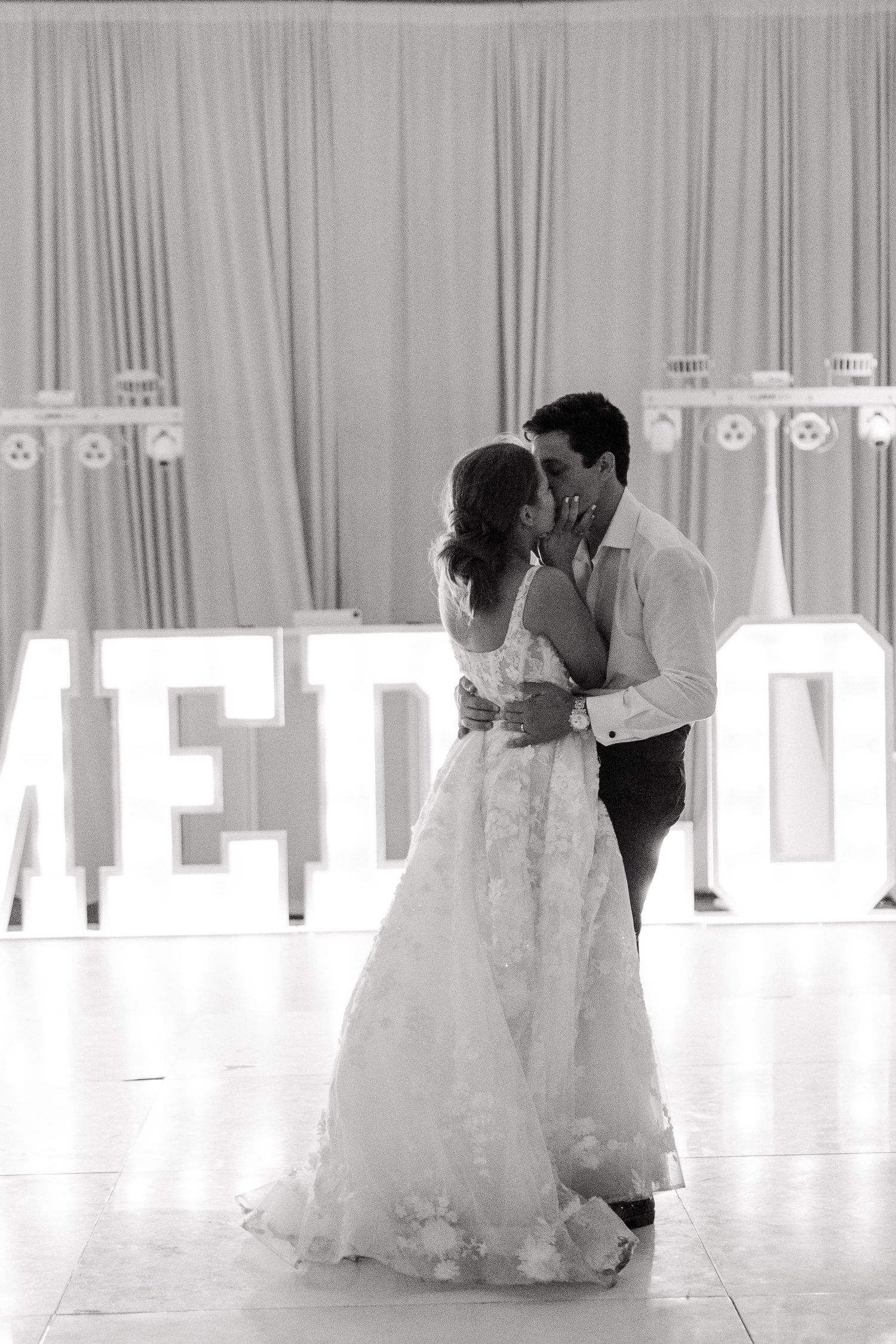 Black and white photo series captures romantic first dance moments at an elegant wedding reception.