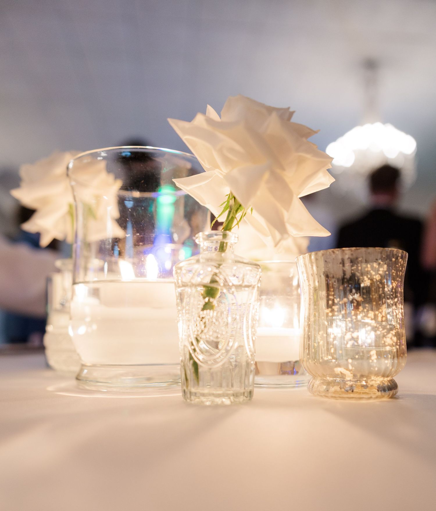 Elegant table setting with crystal glassware and soft candlelight creating romantic ambiance.