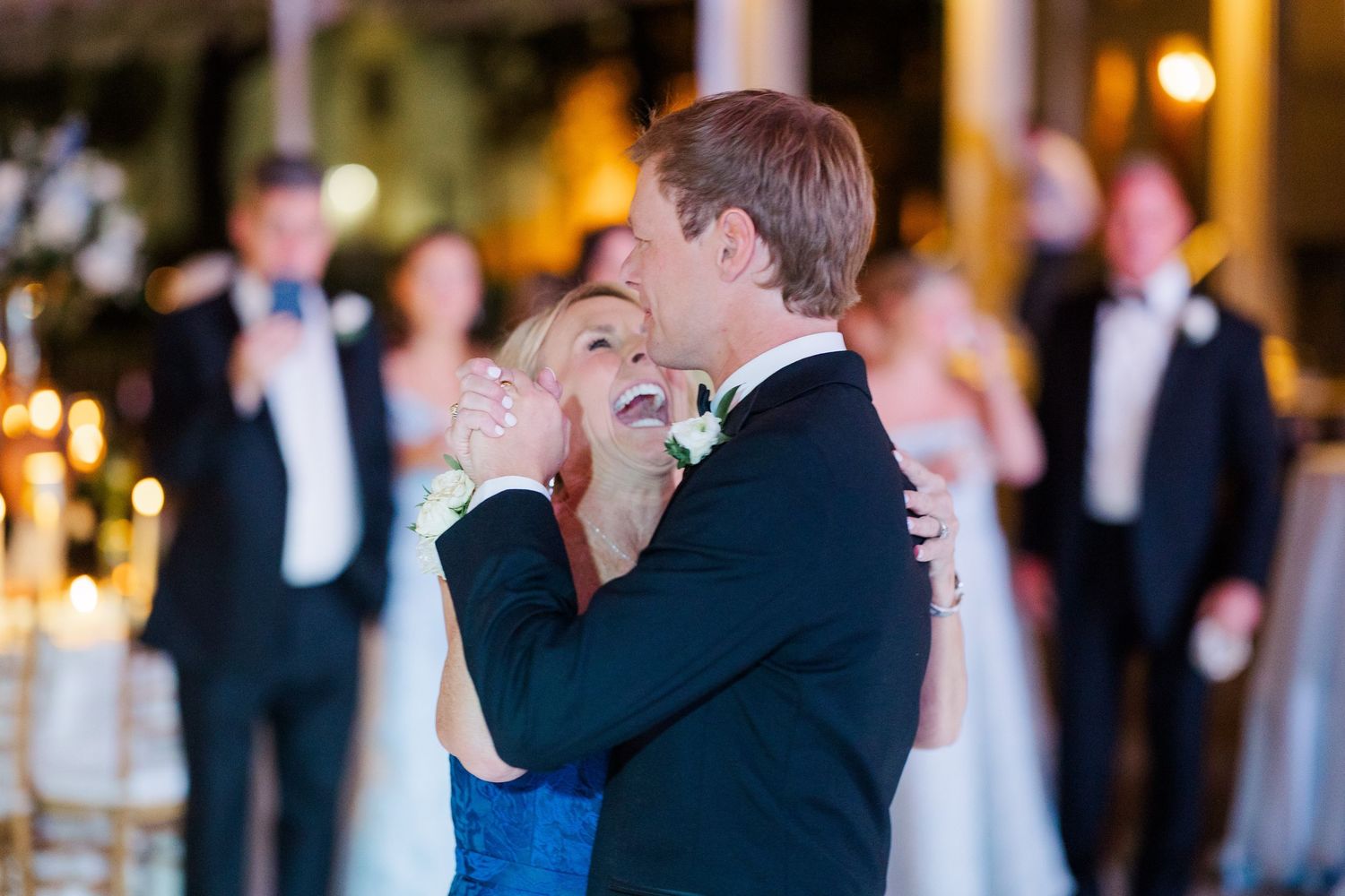 Couple sharing intimate dance moment at evening wedding reception.