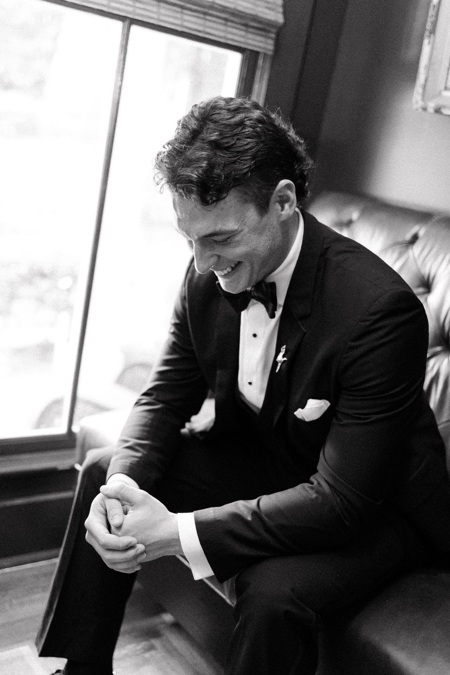 Black and white photo series showing a groom in tuxedo expressing emotional moments before wedding ceremony.
