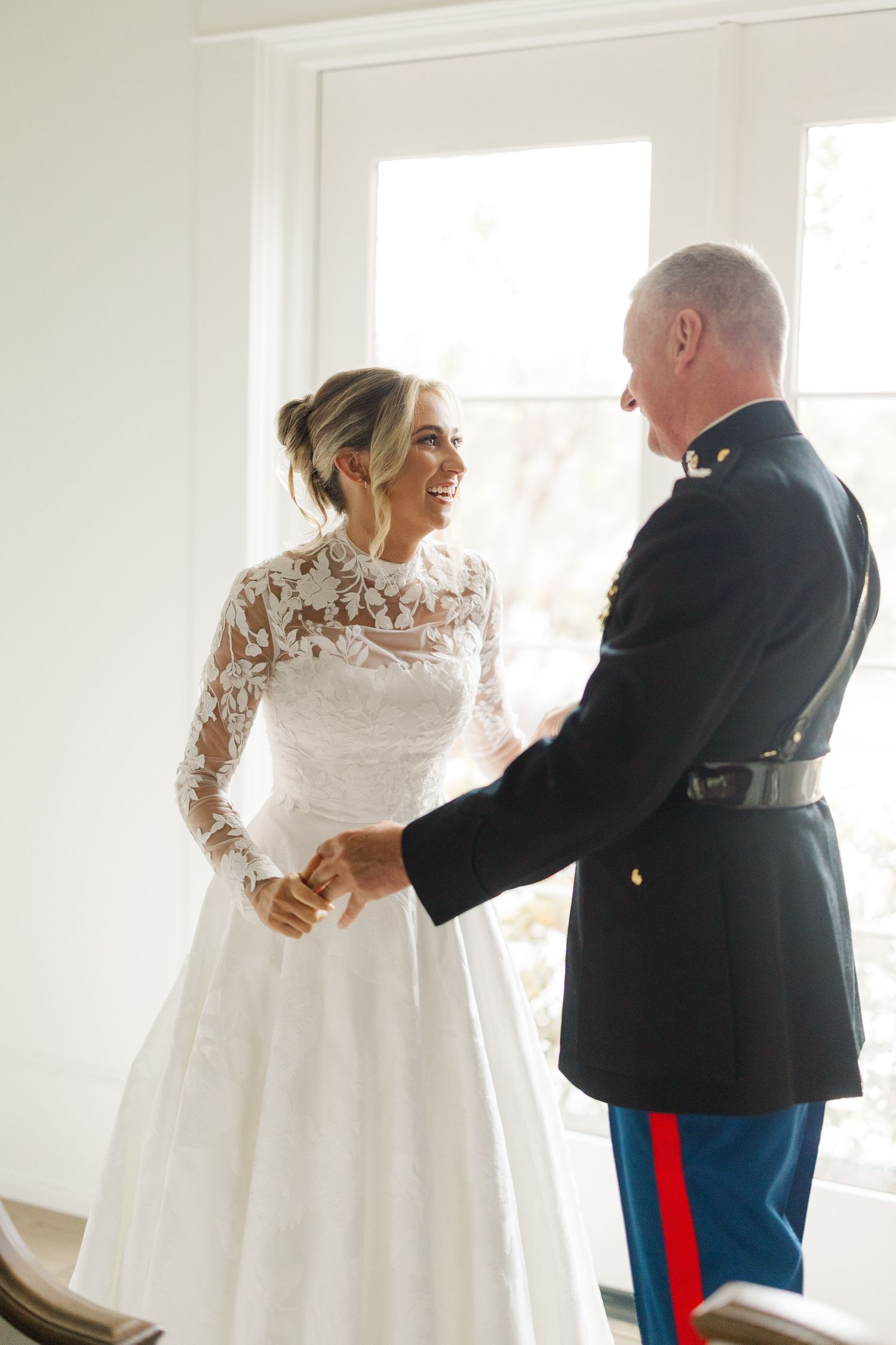 A series of first look photos showing a bride in a lace-sleeved gown with a military officer in dress uniform.