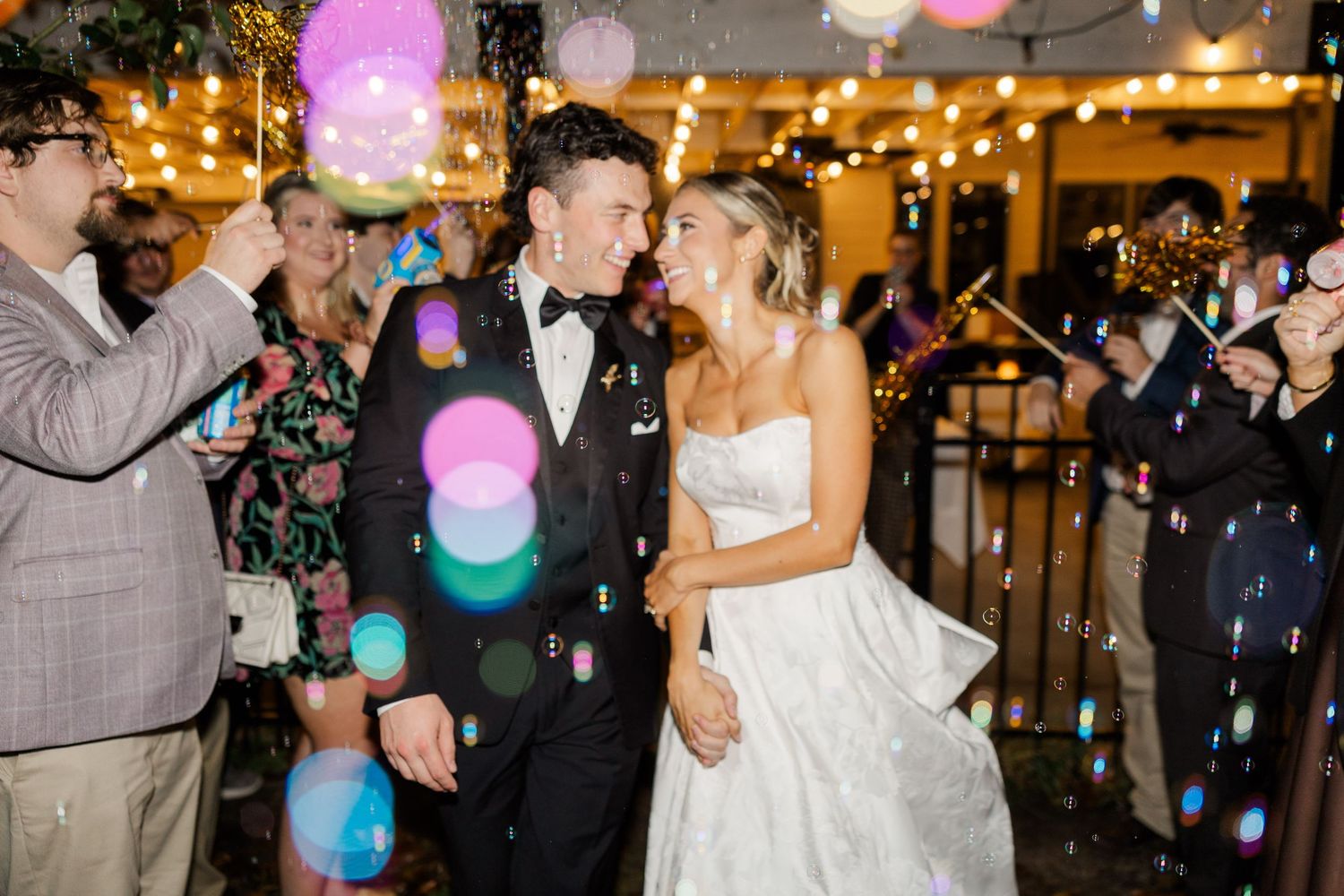 Wedding celebration at night with colorful lights and lanterns creating a festive atmosphere.