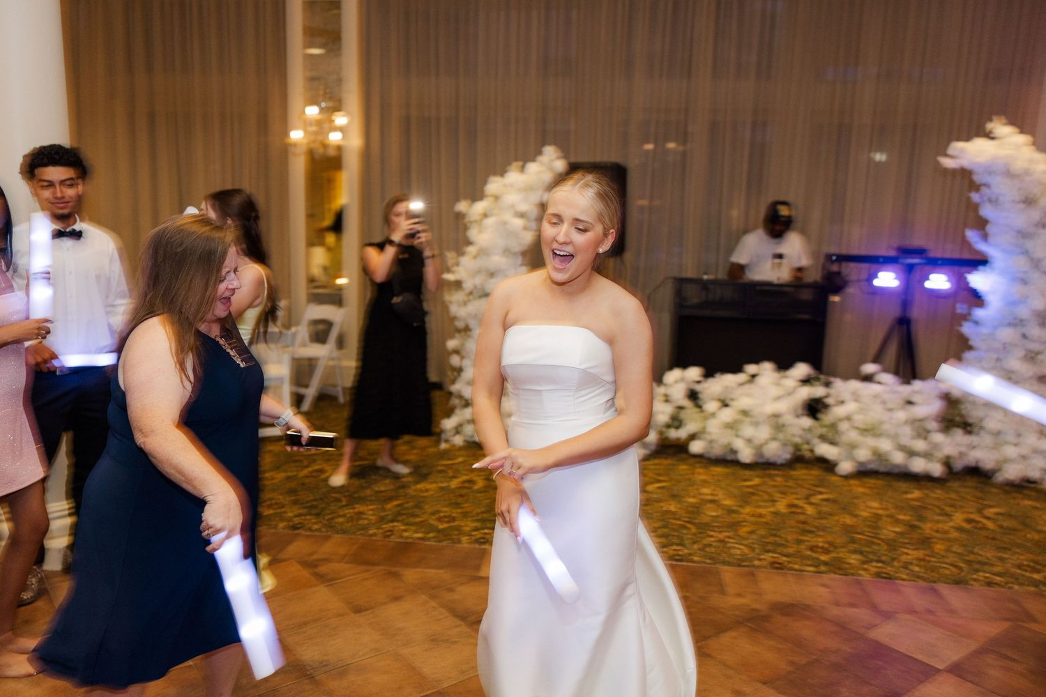Wedding reception dance floor sequence showing couples dancing and celebrating in an elegant ballroom setting.