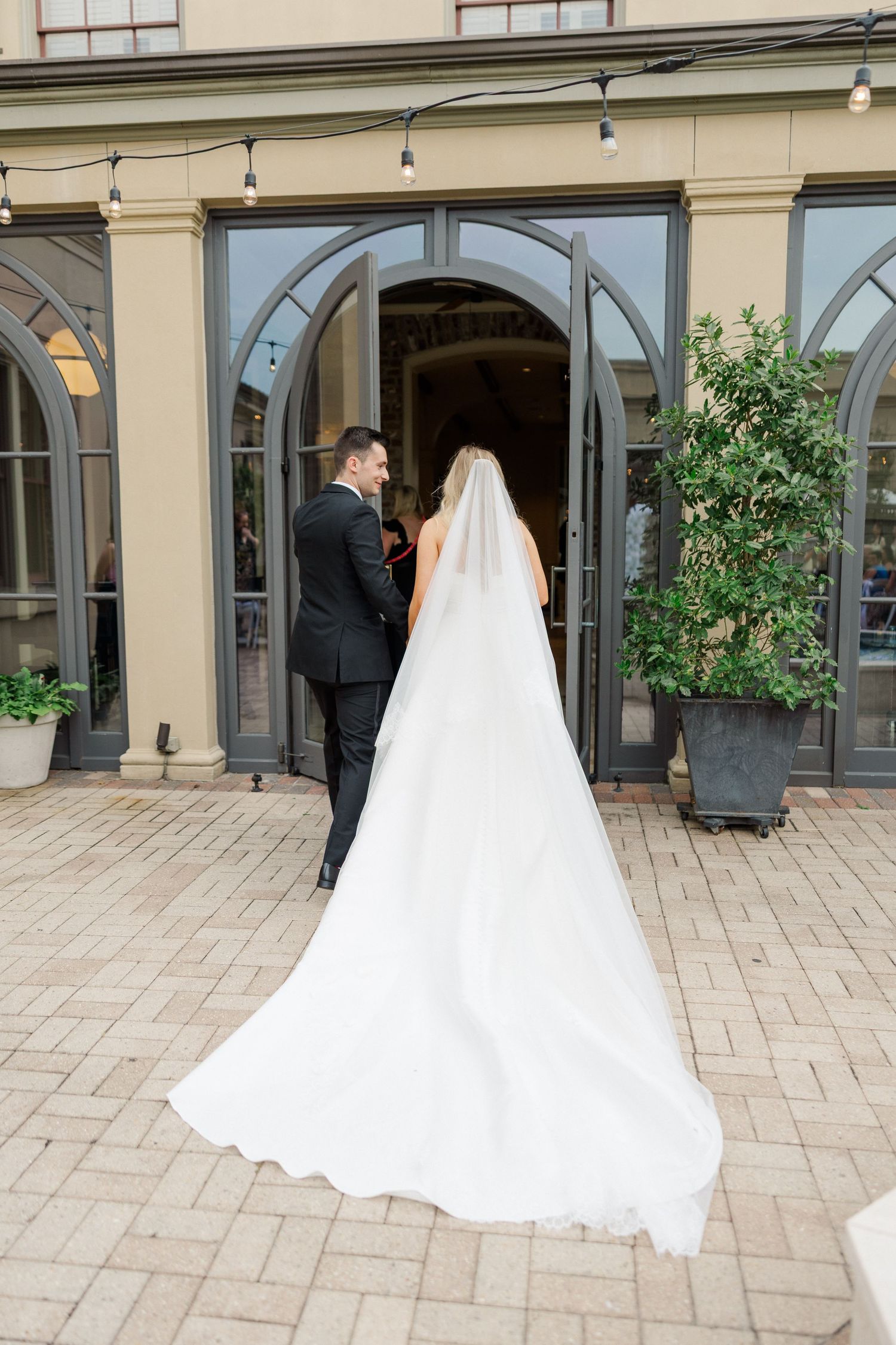 Wedding ceremony location showing architectural details and stone patio with greenery.