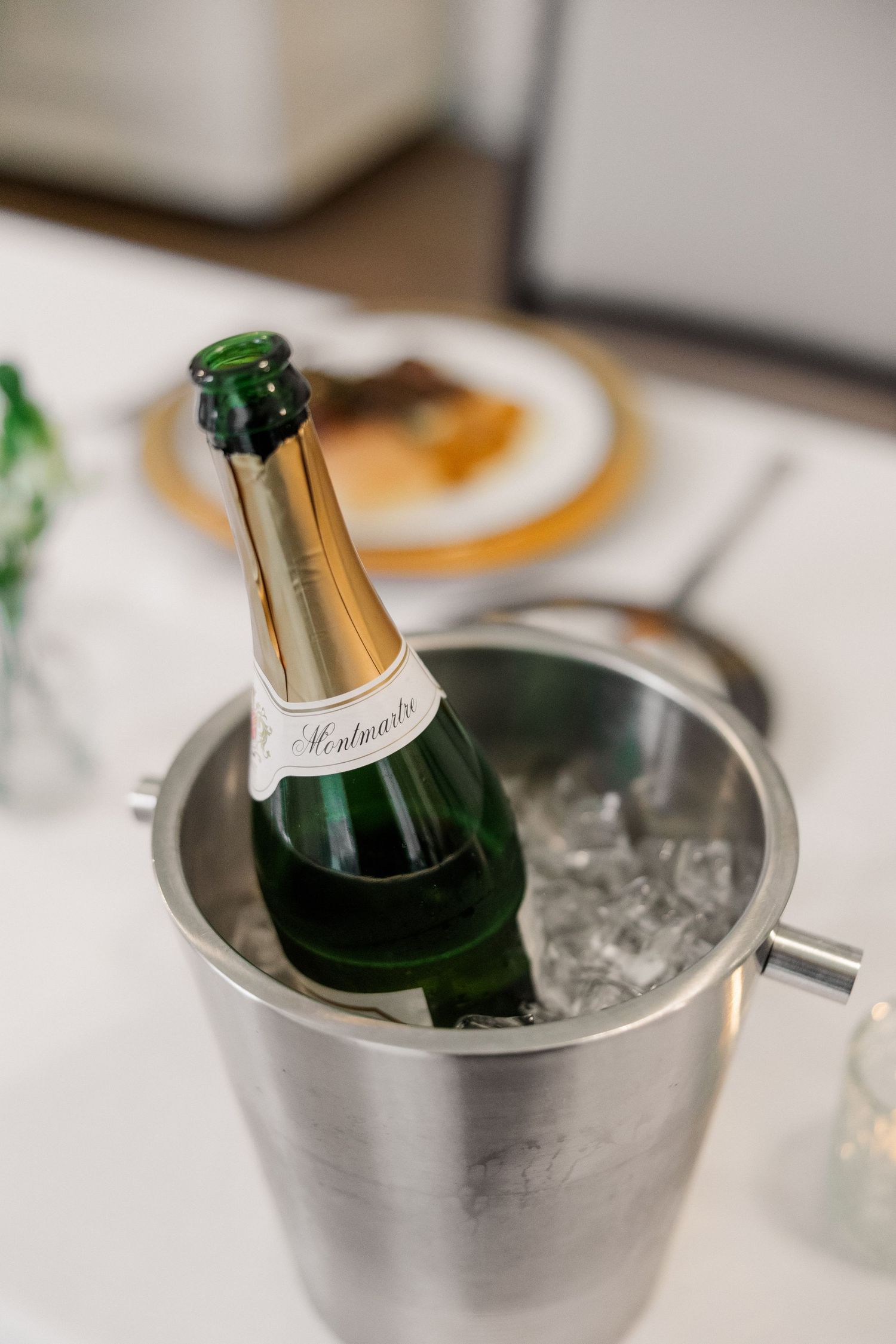 Champagne bottles chilling in silver ice buckets at an elegant wedding reception.