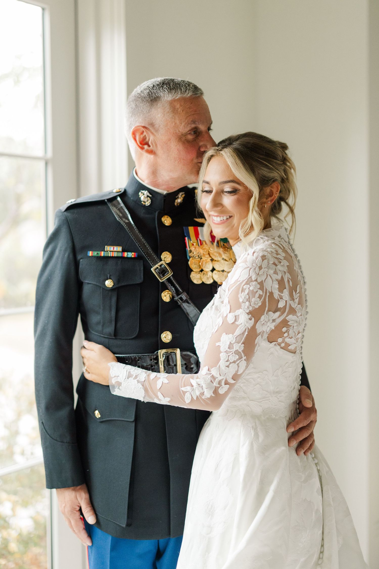 Military wedding ceremony with formal dress uniforms in a sunlit chapel setting.