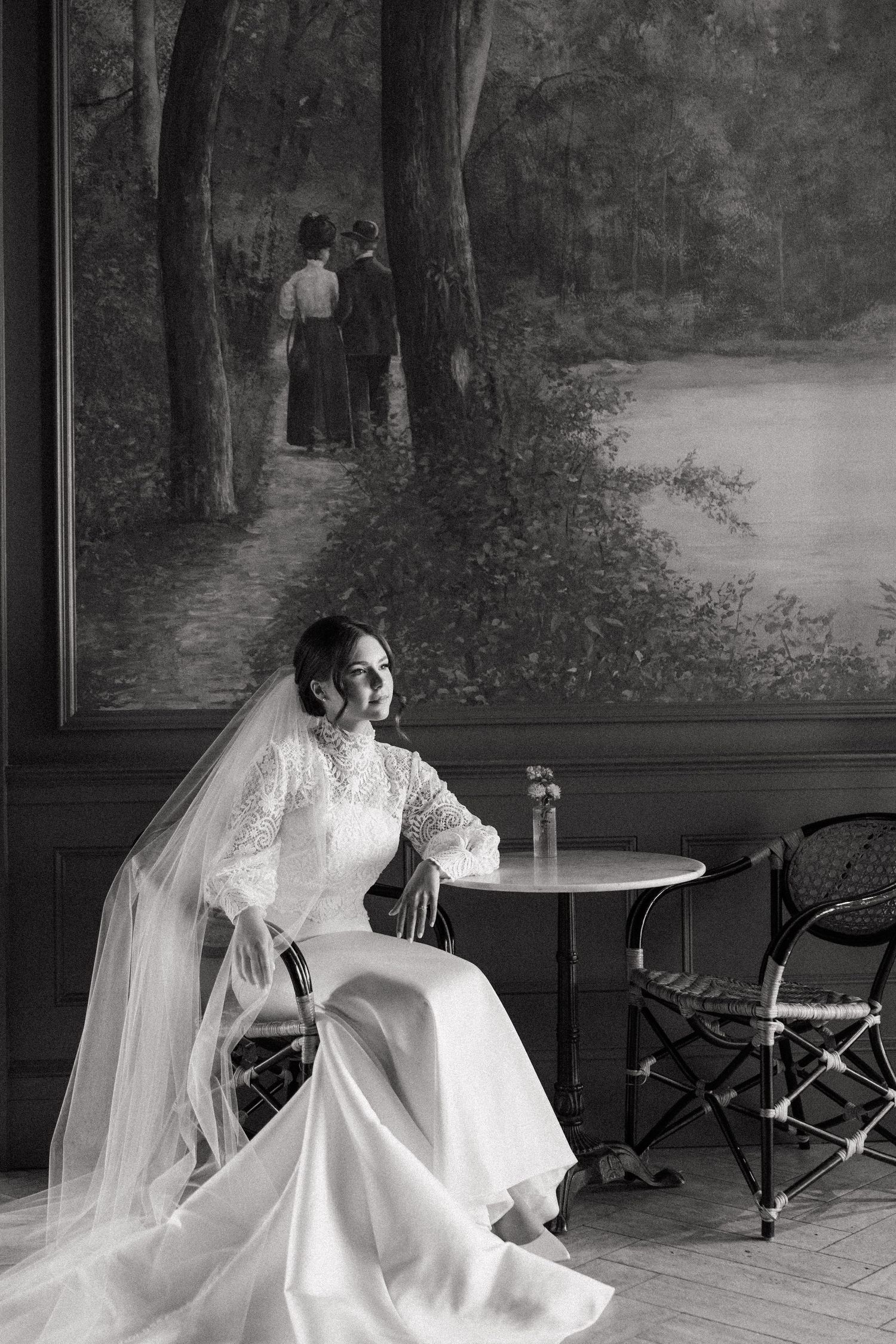 Elegant bridal portraits in black and white showing flowing wedding dress and veil against a scenic backdrop.