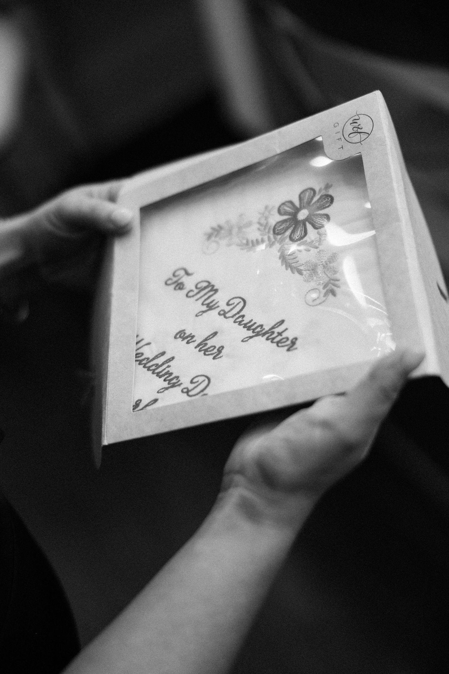 Close-up of decorative wedding invitation card with floral details.