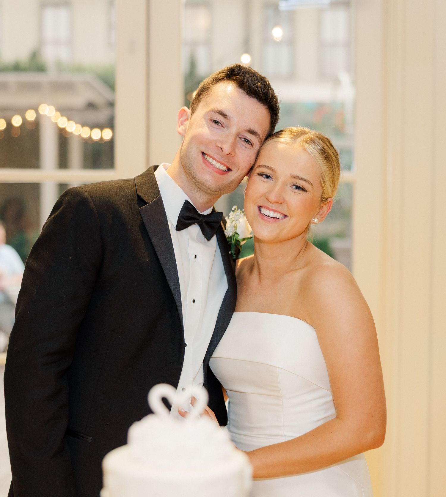 Romantic wedding dance sequence showing candid moments in a bright elegant ballroom setting.