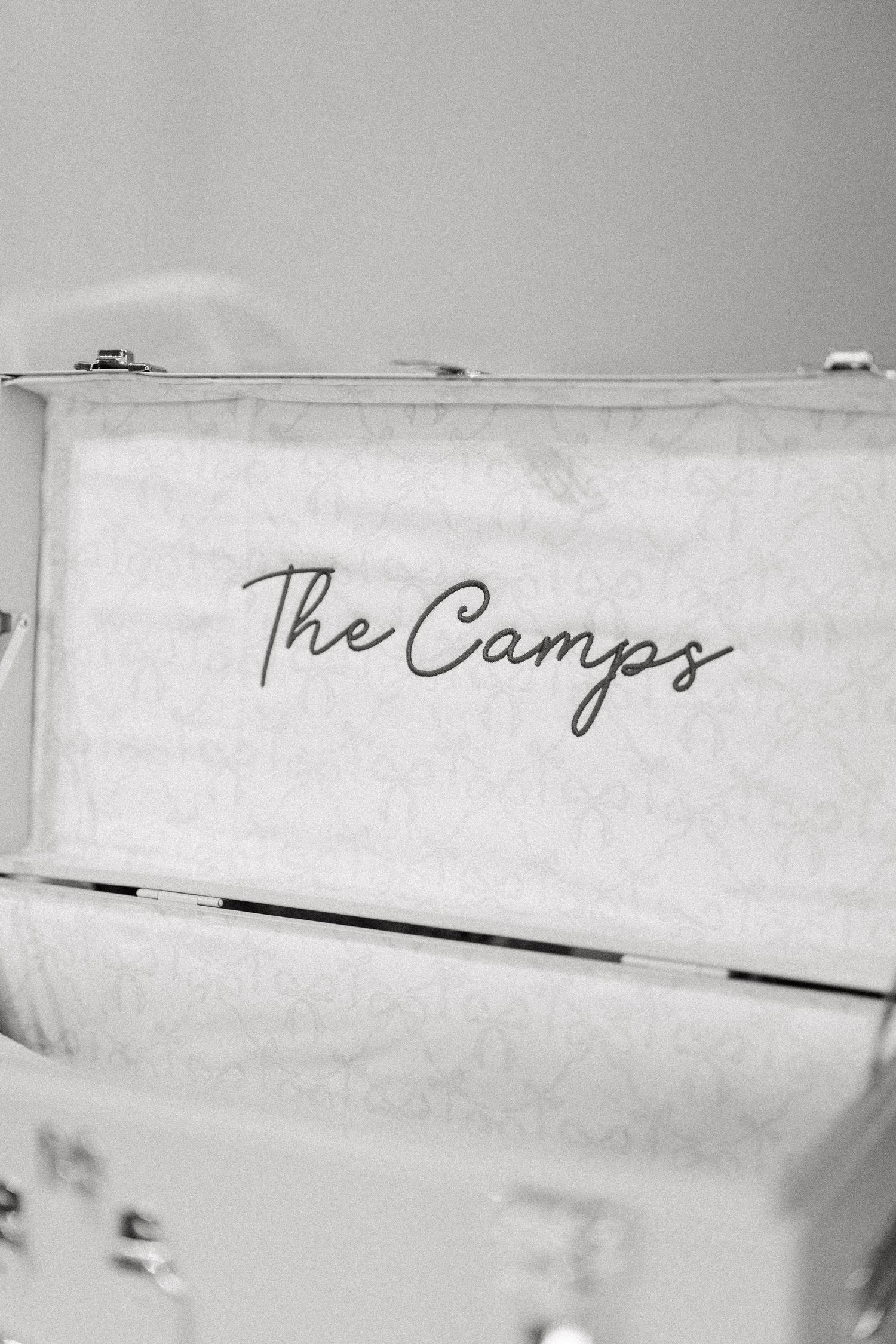 Handwritten text reading 'The Campus' appears on a white surface in black ink with minimal contrast.