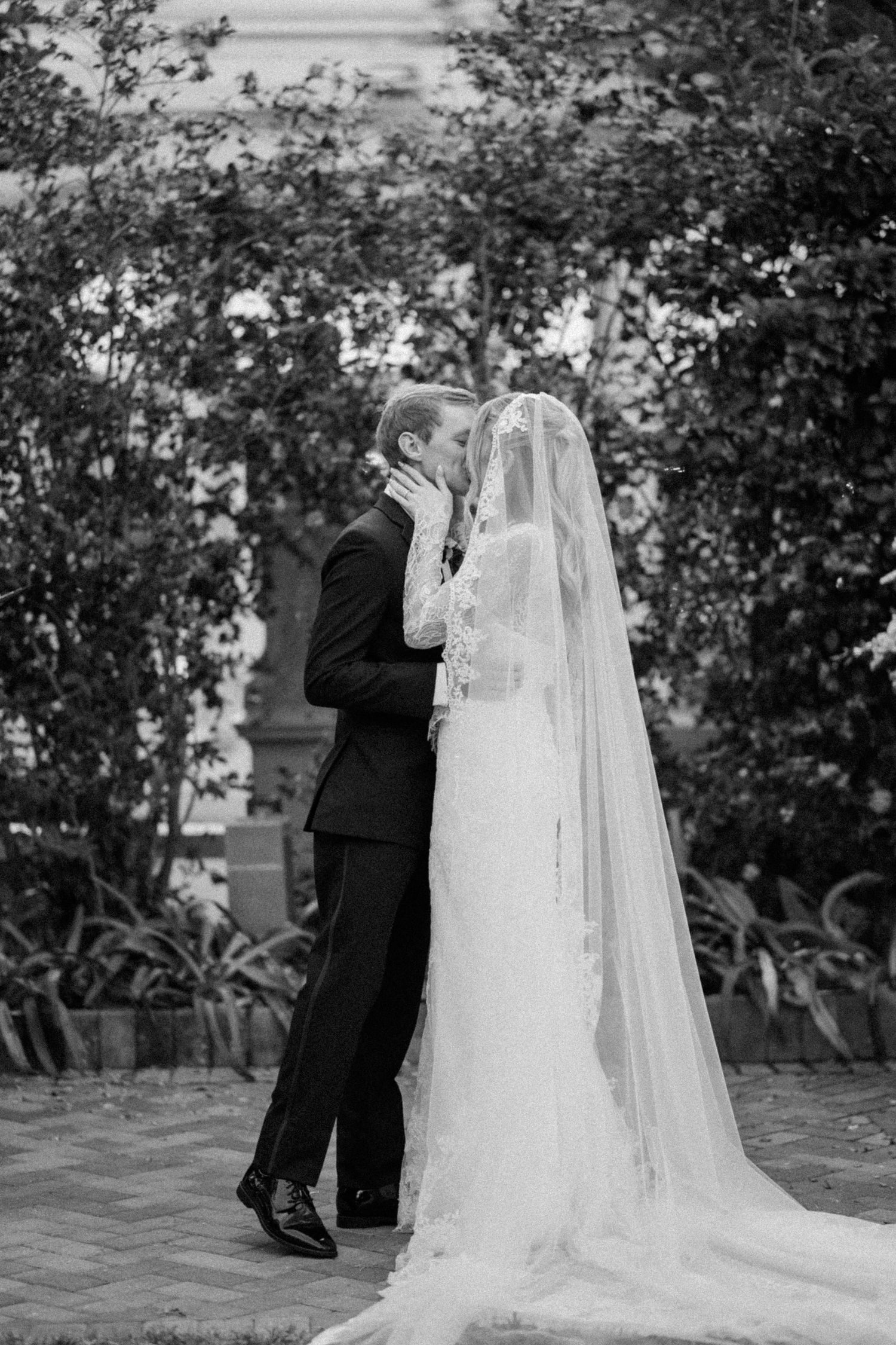 Black and white wedding photos capturing intimate moments on a garden terrace.