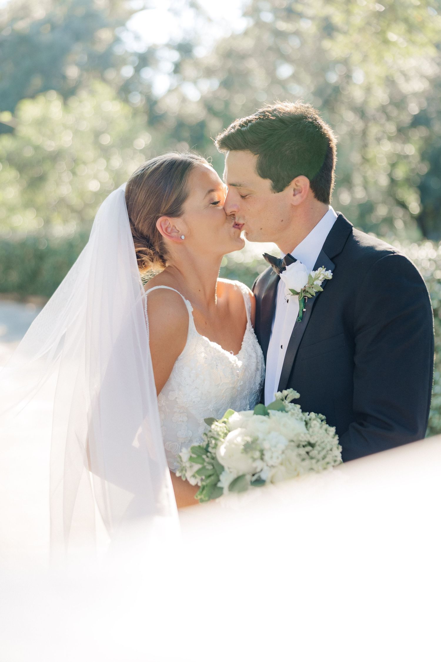 Romantic wedding portrait sequence captured in soft natural sunlight.