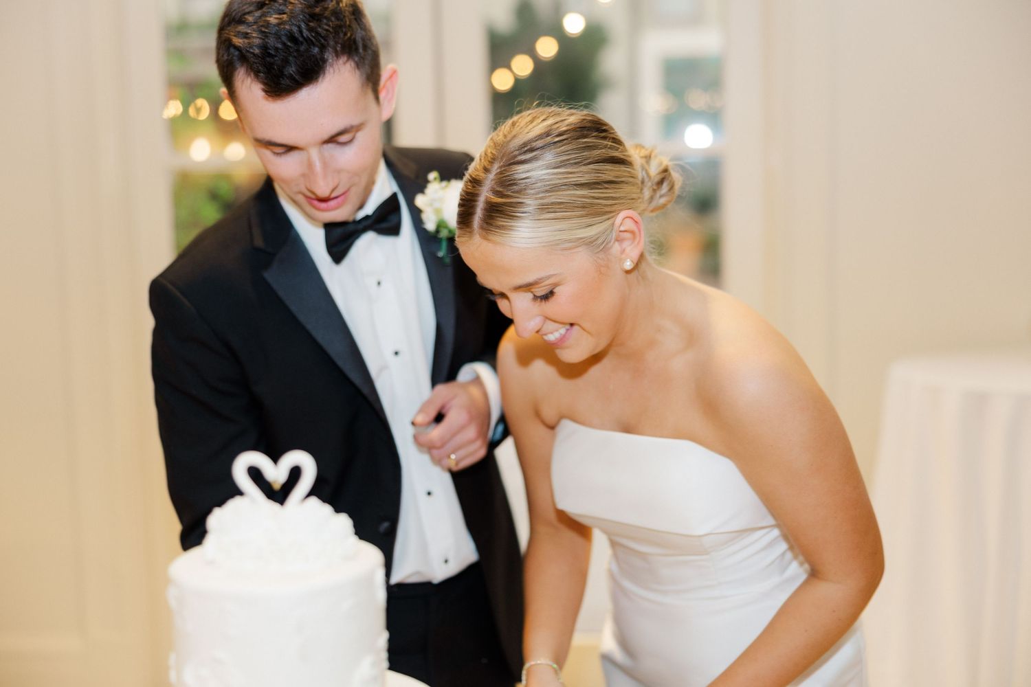 Candid reception moments showing laughter and dancing in a beautifully lit ballroom venue.