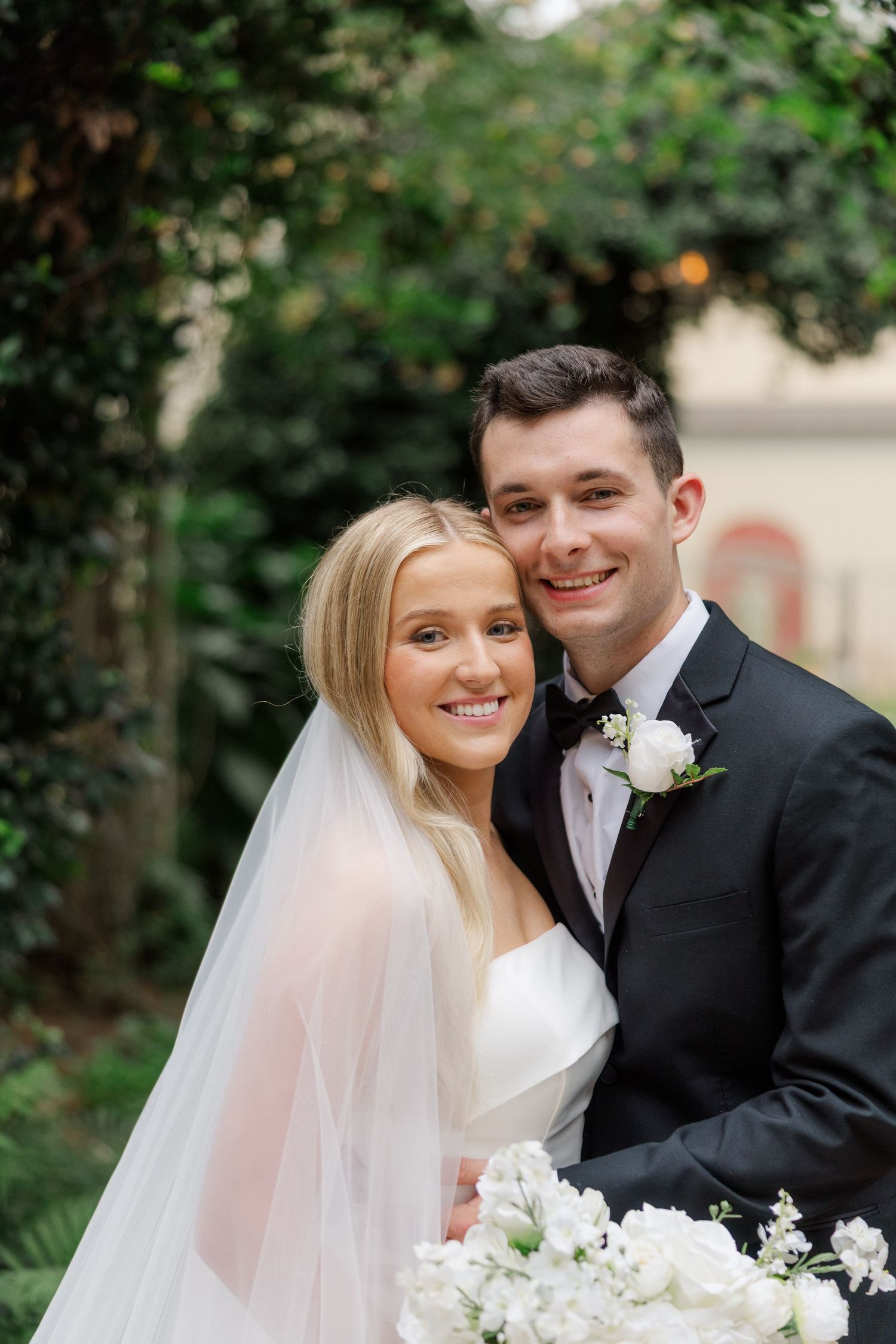 Intimate wedding portraits captured in a lush garden setting with natural lighting.