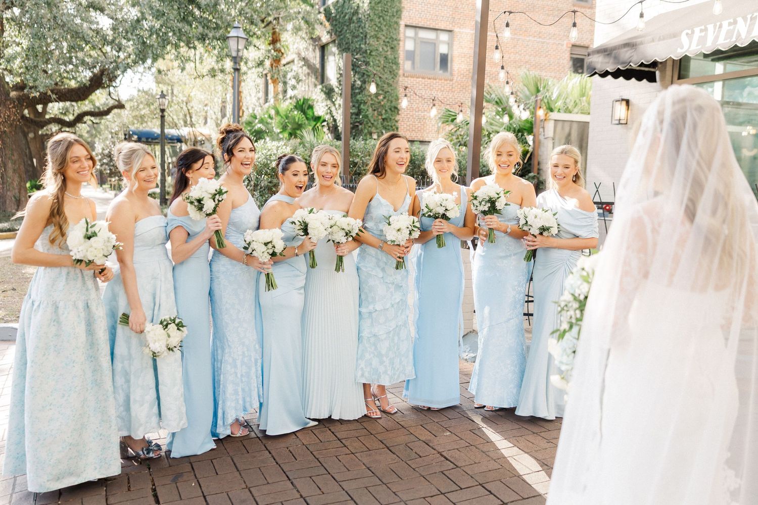 Bridesmaids in light blue dresses pose together in a collage of wedding party photos at an outdoor venue.