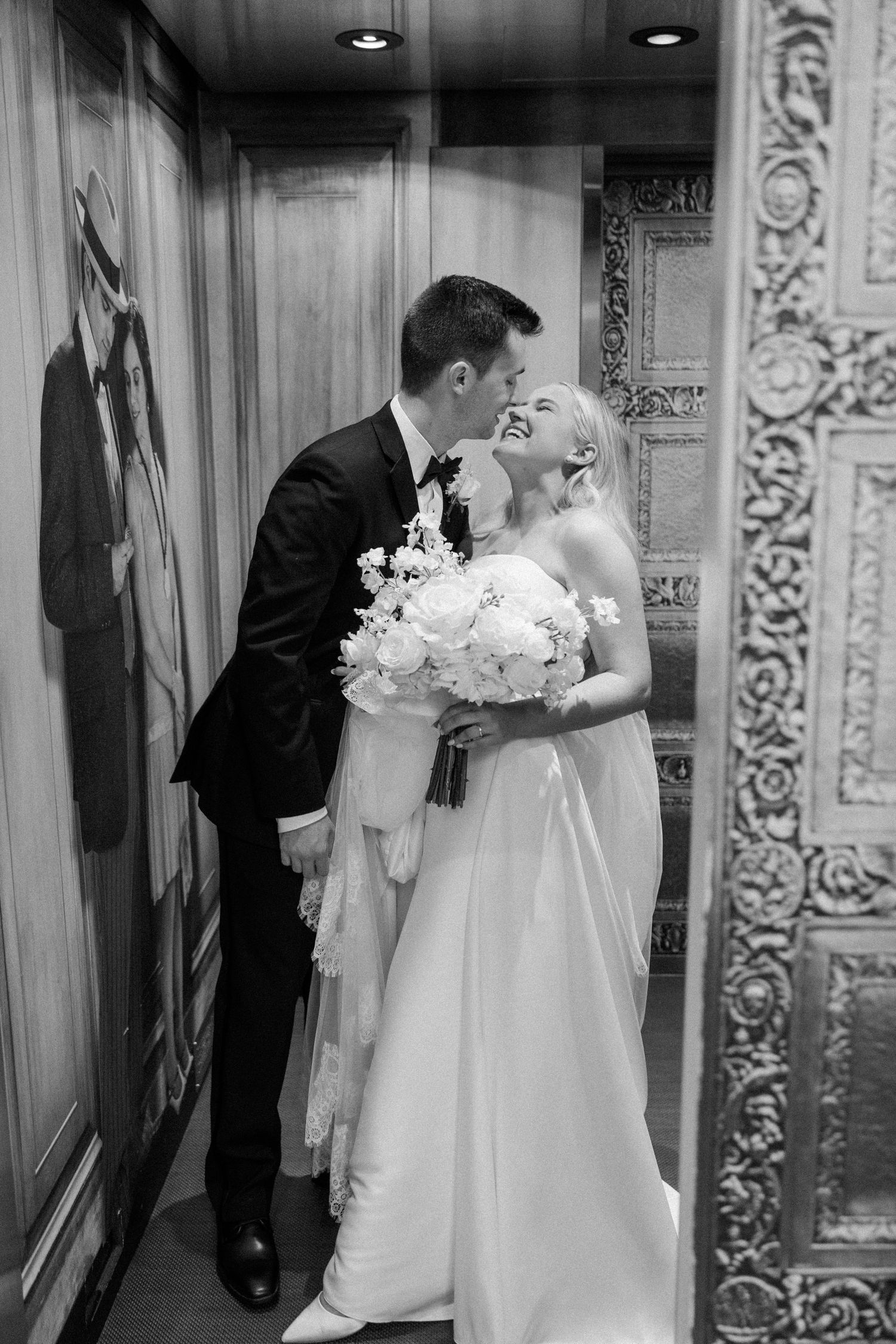 Black and white wedding photos showing romantic moments with white bouquet and ornate architectural details.