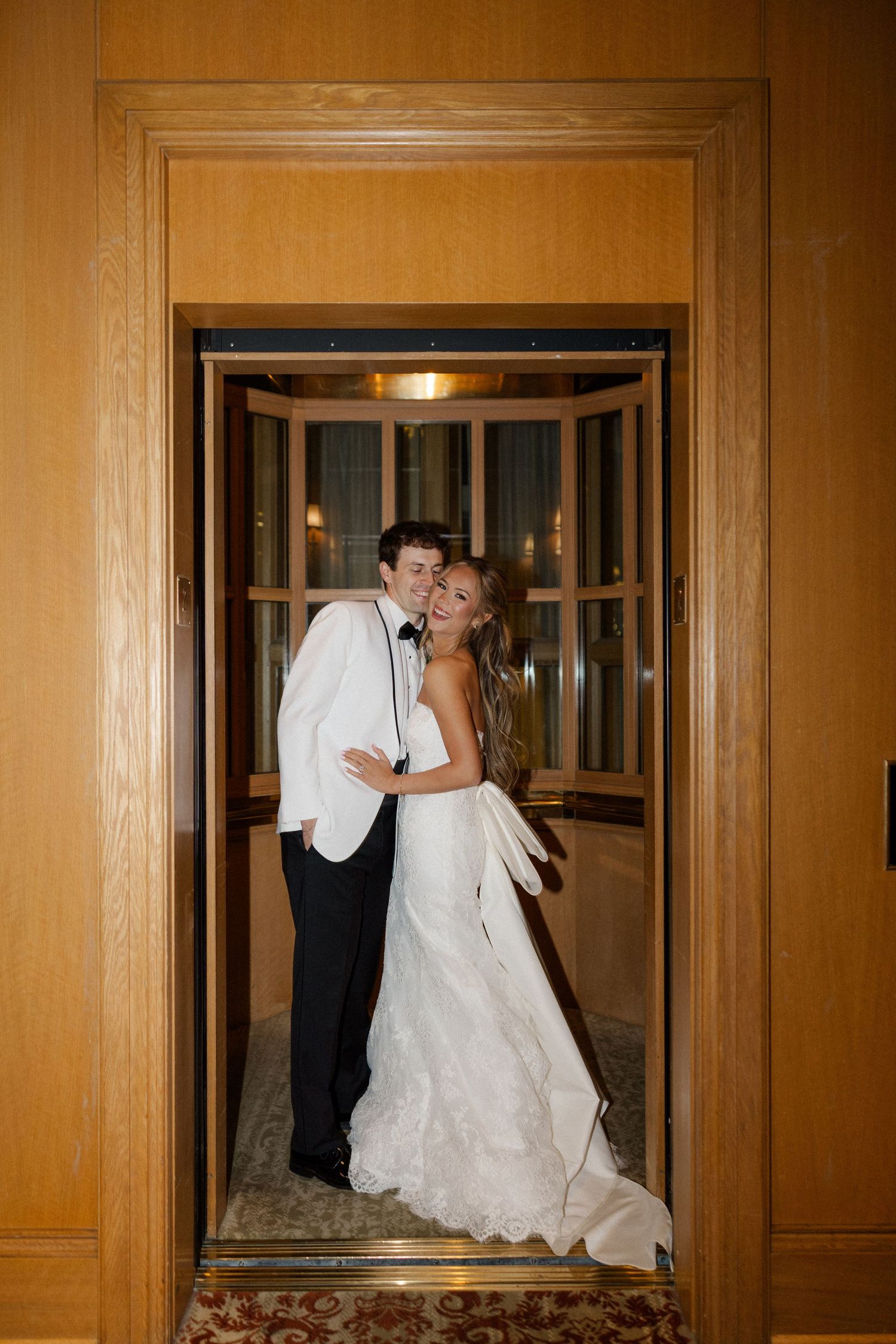 Series of wedding photos showing playful moments through elevator doors in a wood-paneled hallway.