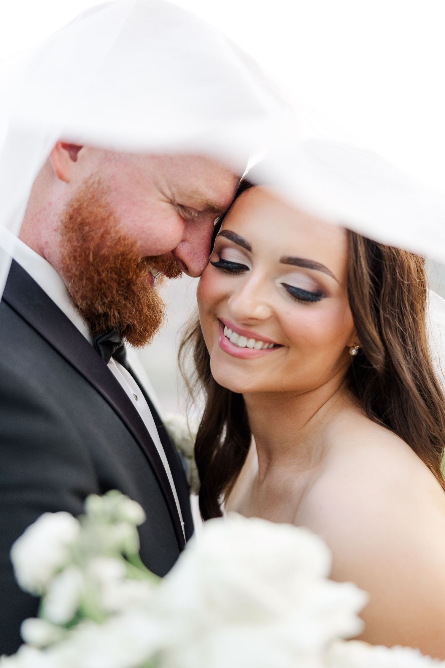 Close-up wedding portraits capturing intimate moments and smiles in soft natural light.