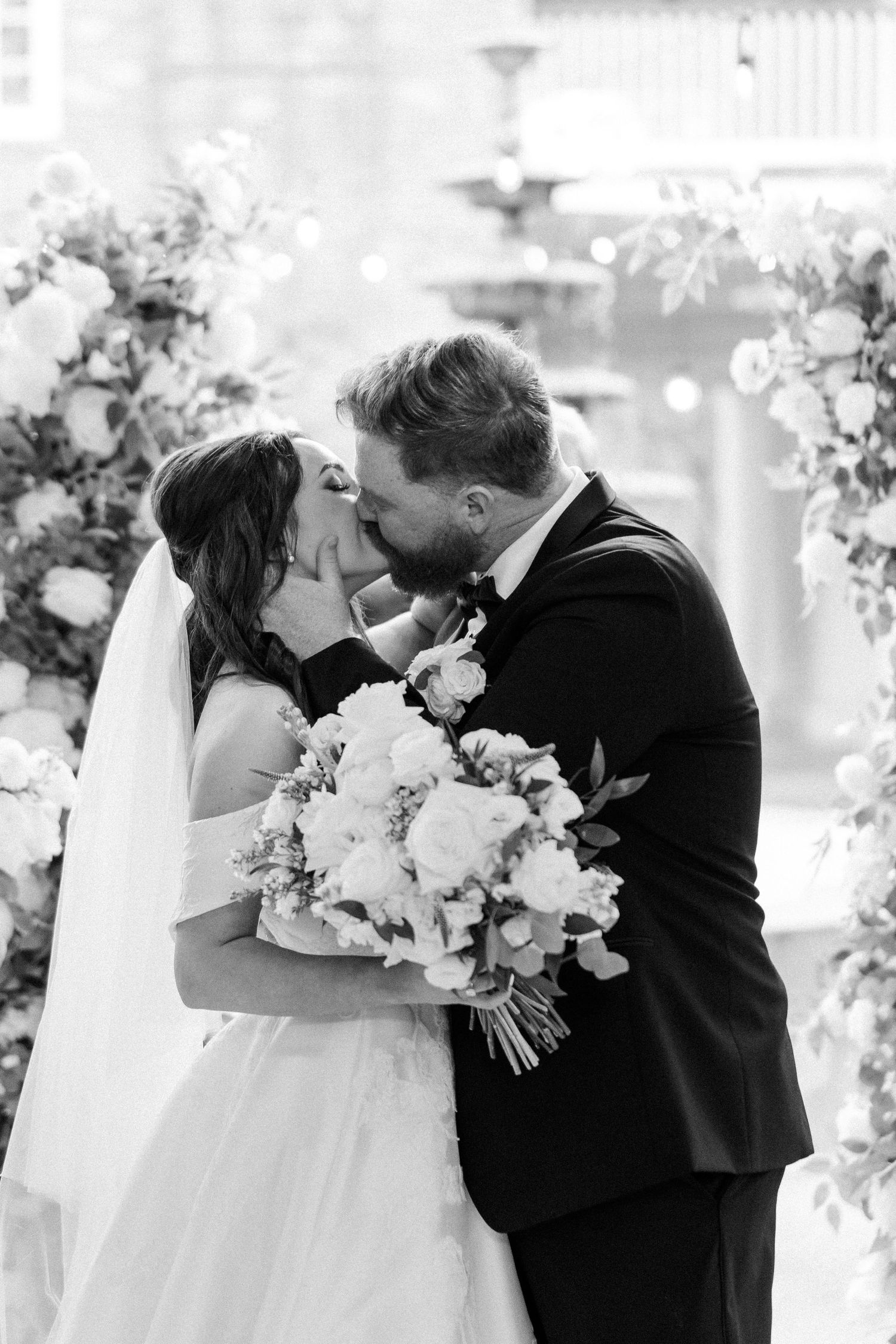 Romantic black and white wedding portraits with elegant white floral bouquet.